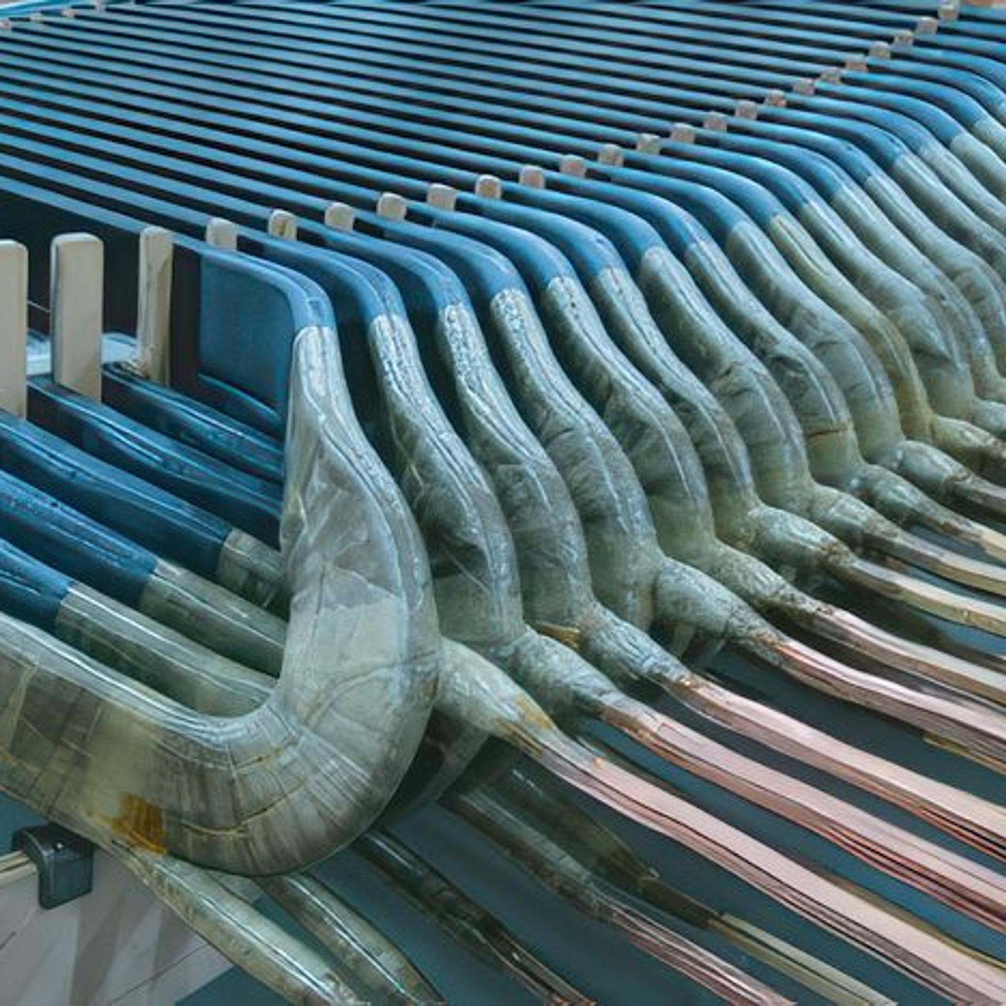 Insulated stator windings and copper conductors arranged inside a large electric motor.