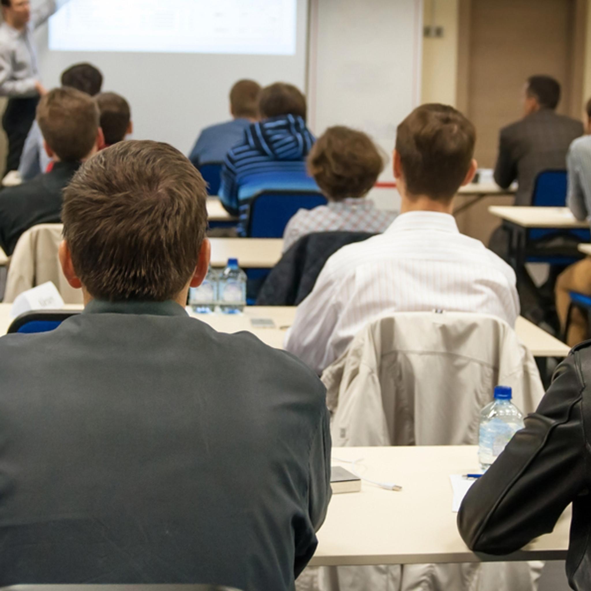 Employees attend a classroom training session led by an instructor.