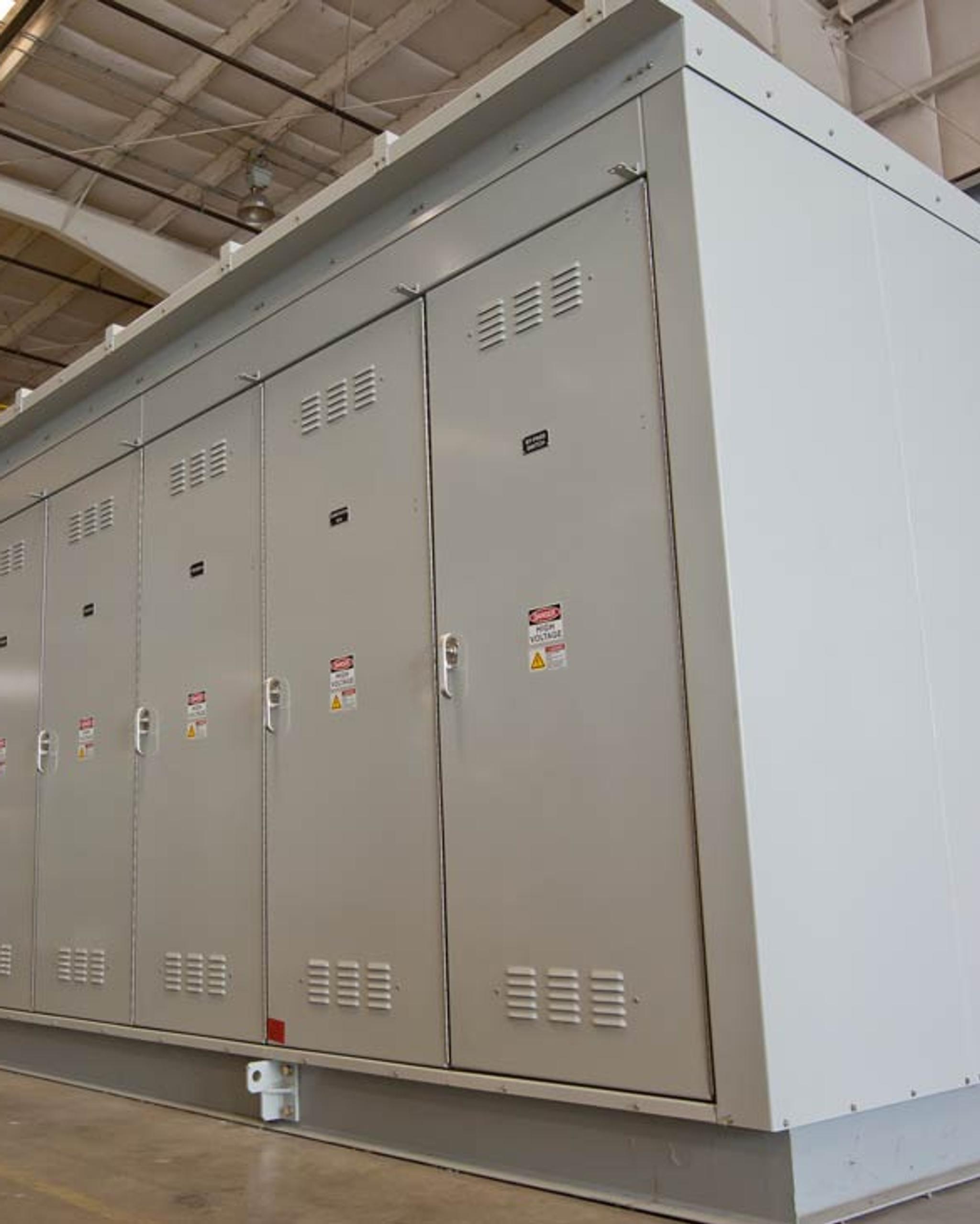 Grand appareillage de commutation électrique à plusieurs compartiments dans un atelier industriel.