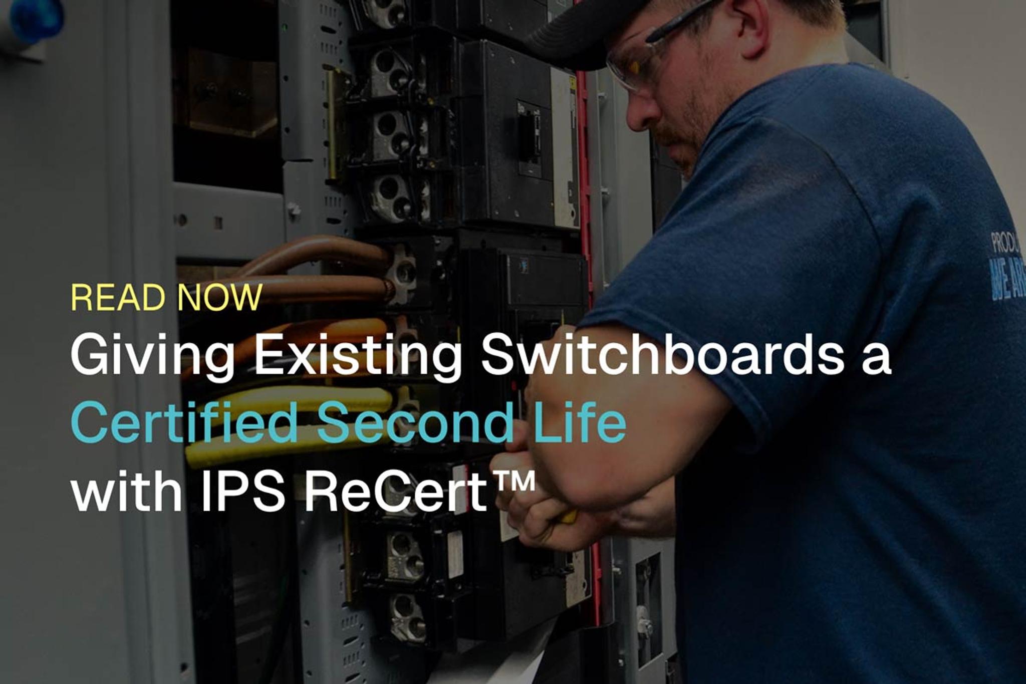 A man in safety glasses and a cap works on an open electrical switchboard, promoting IPS ReCert™.