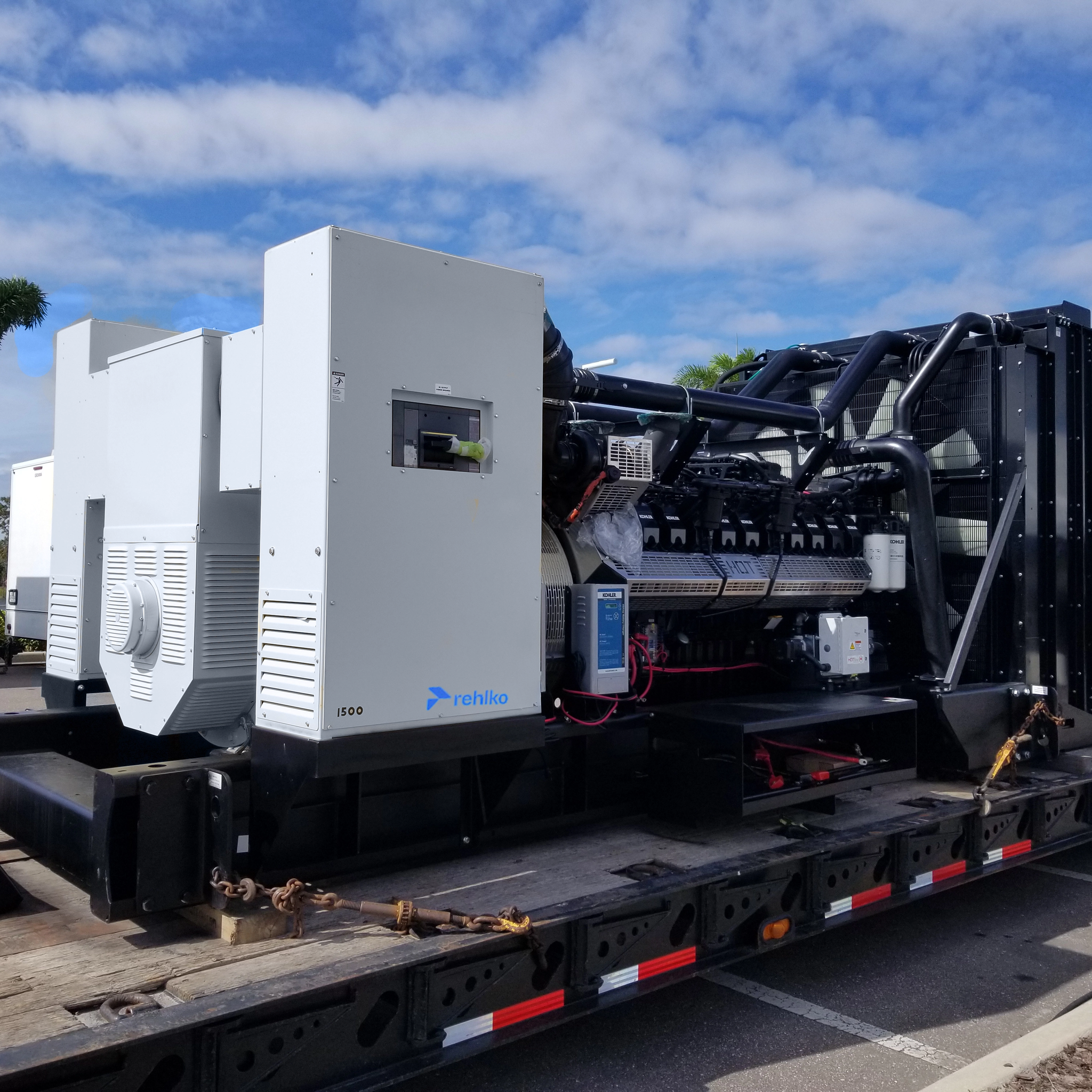 Industrial diesel generator and radiator secured on a flatbed trailer