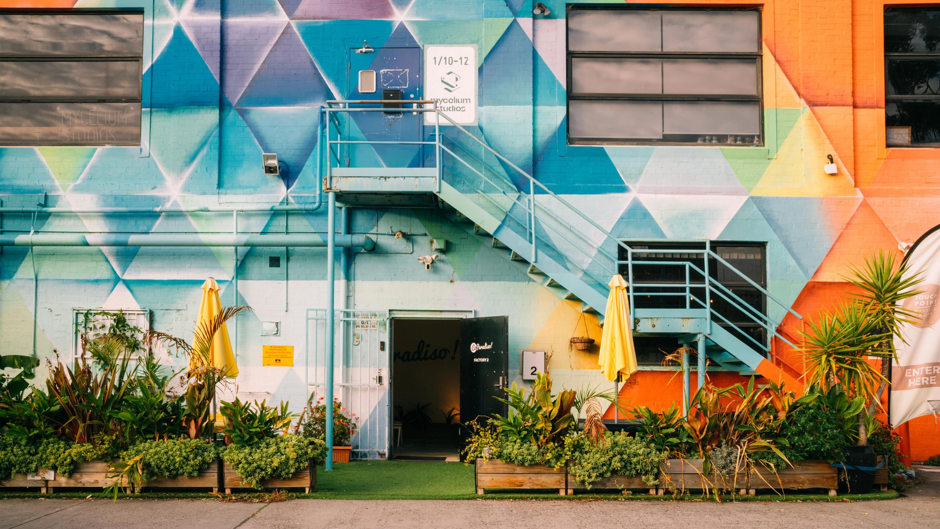 Some colourful fold-out chairs by an outdoor pool