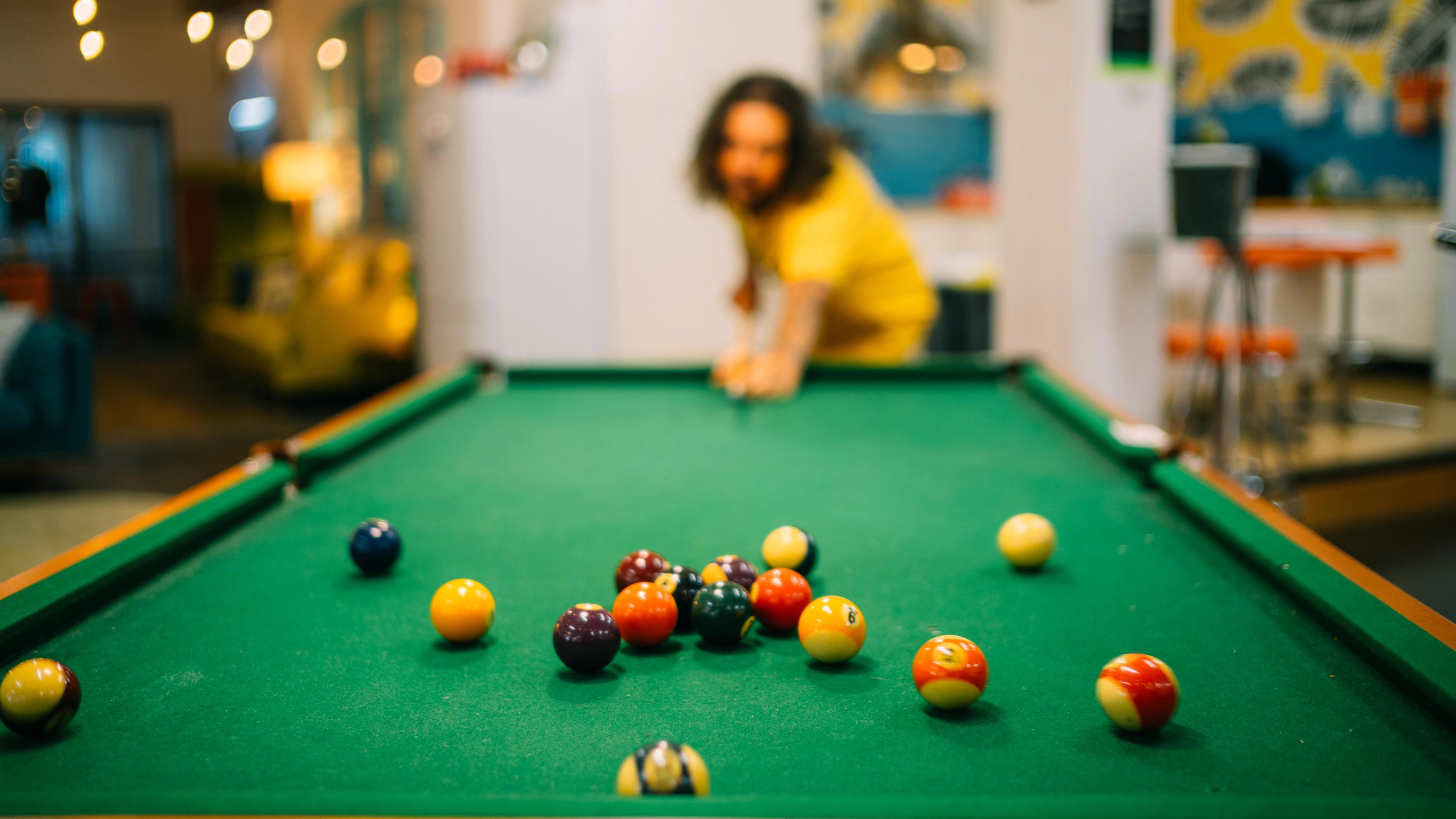 A member playing pool. 
