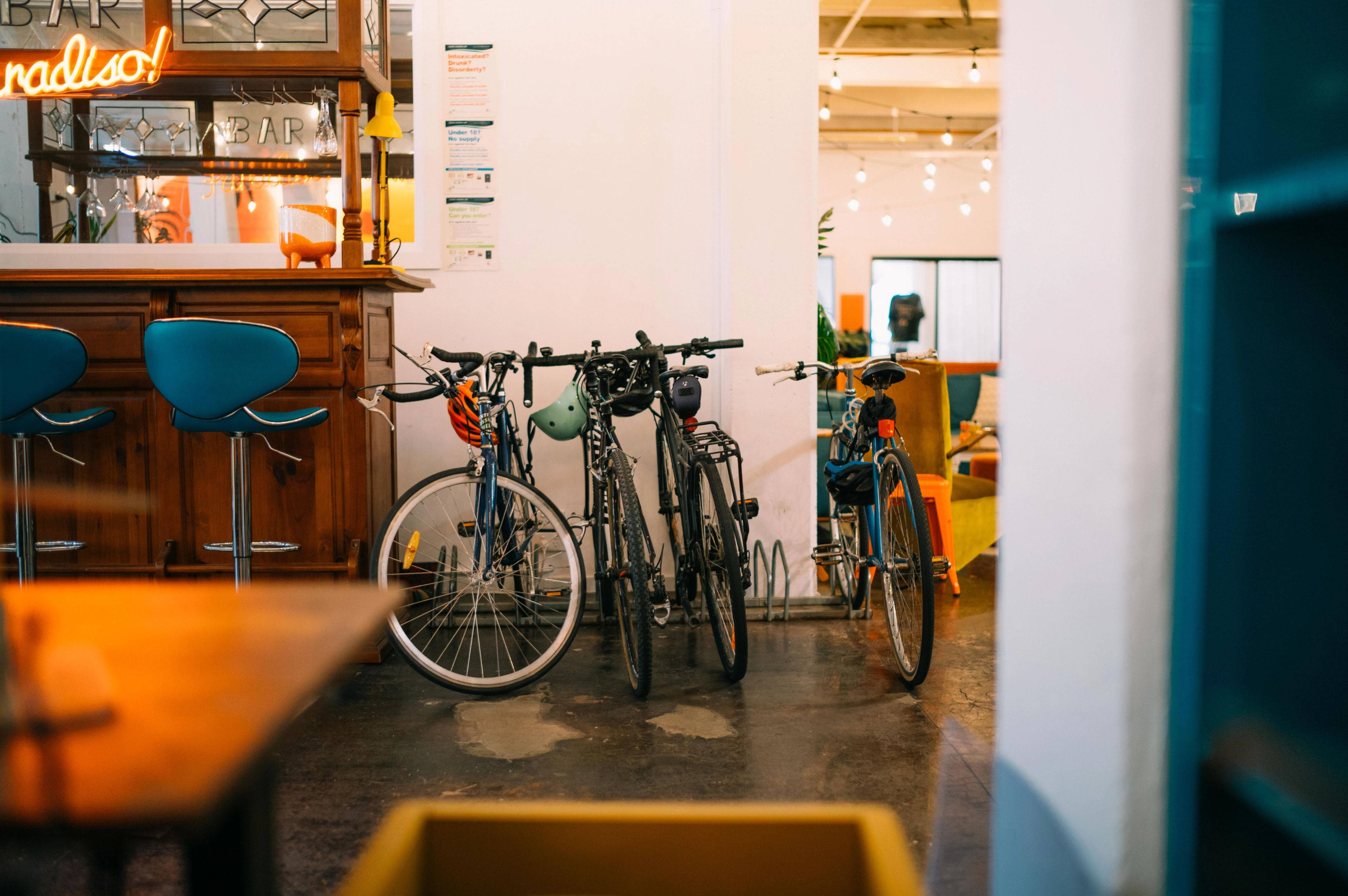 Four bicycles racked up in a corner of a room