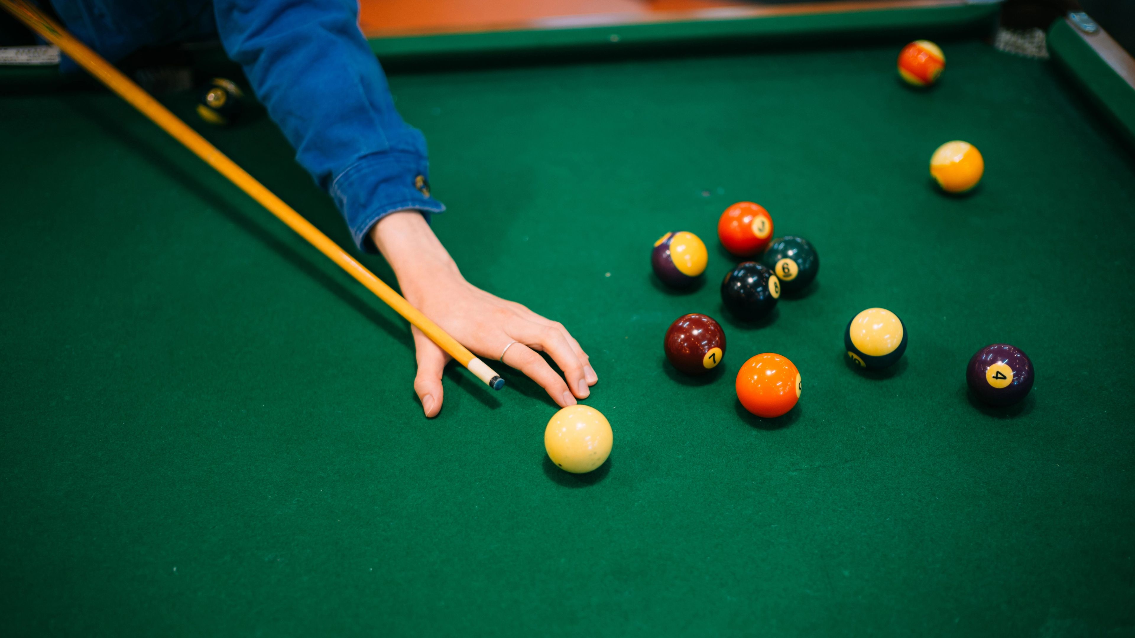 Someone playing pool. Close up of their hand. 