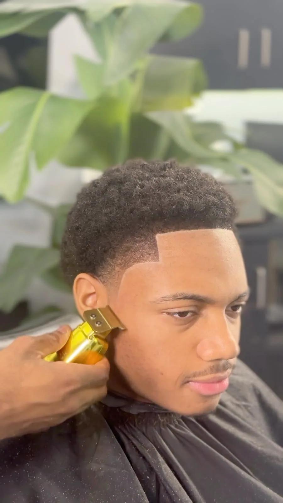 Afro taper with a sharp line-up at Chair and Blade