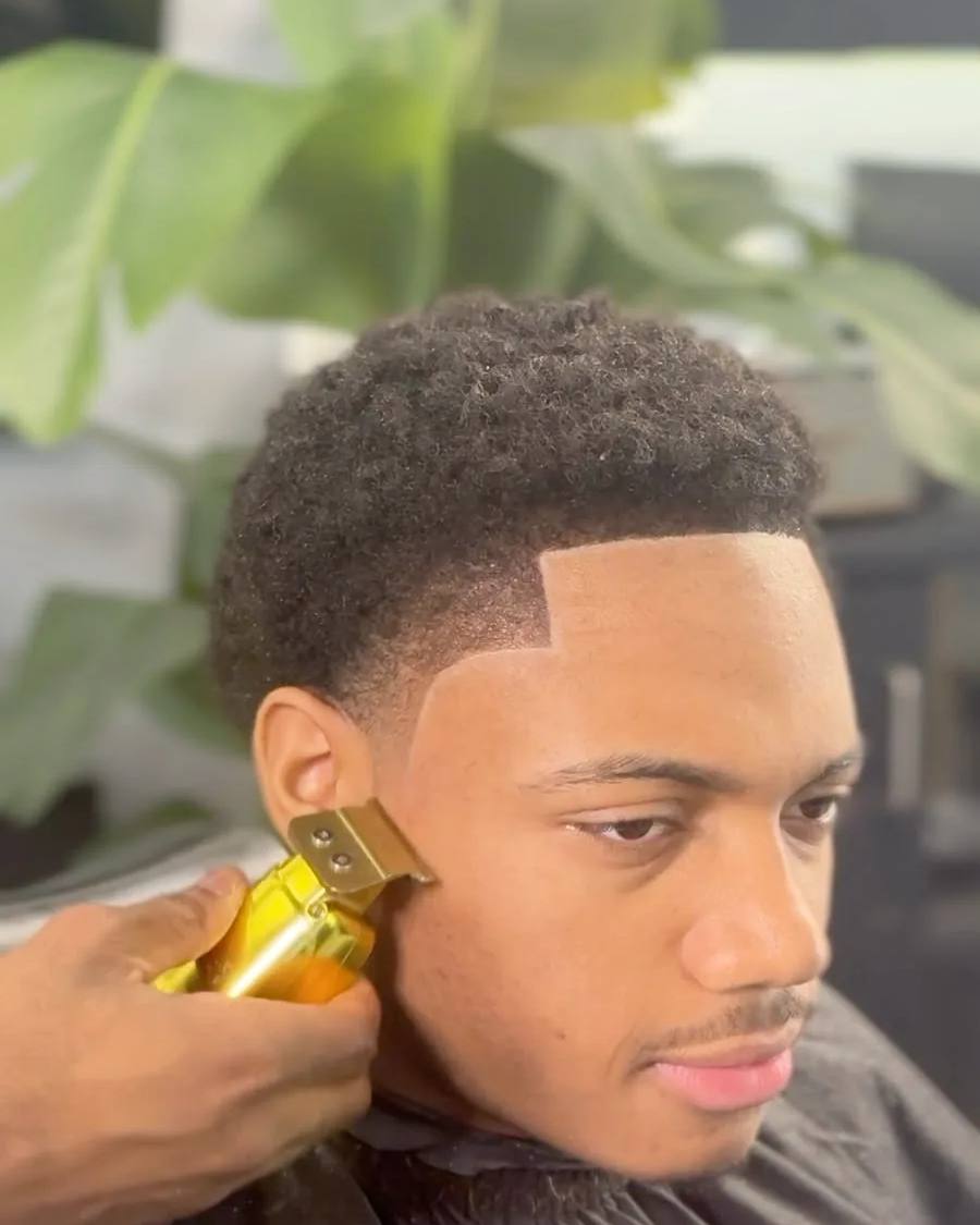 Afro taper with a sharp line-up at Chair and Blade