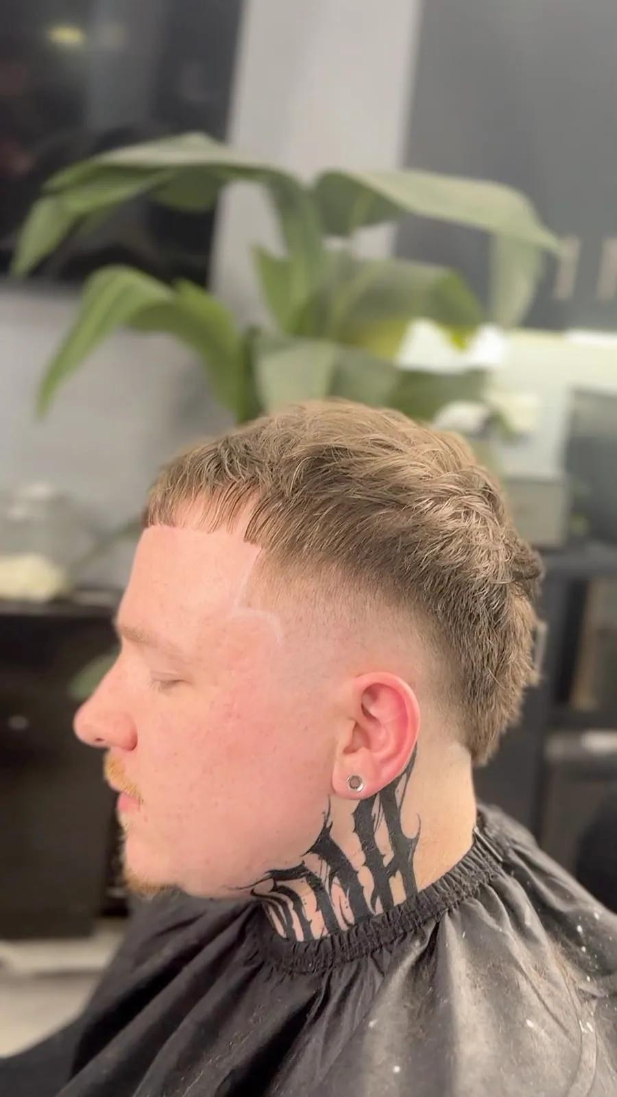 Burst fade with a neck tattoo at Chair and Blade