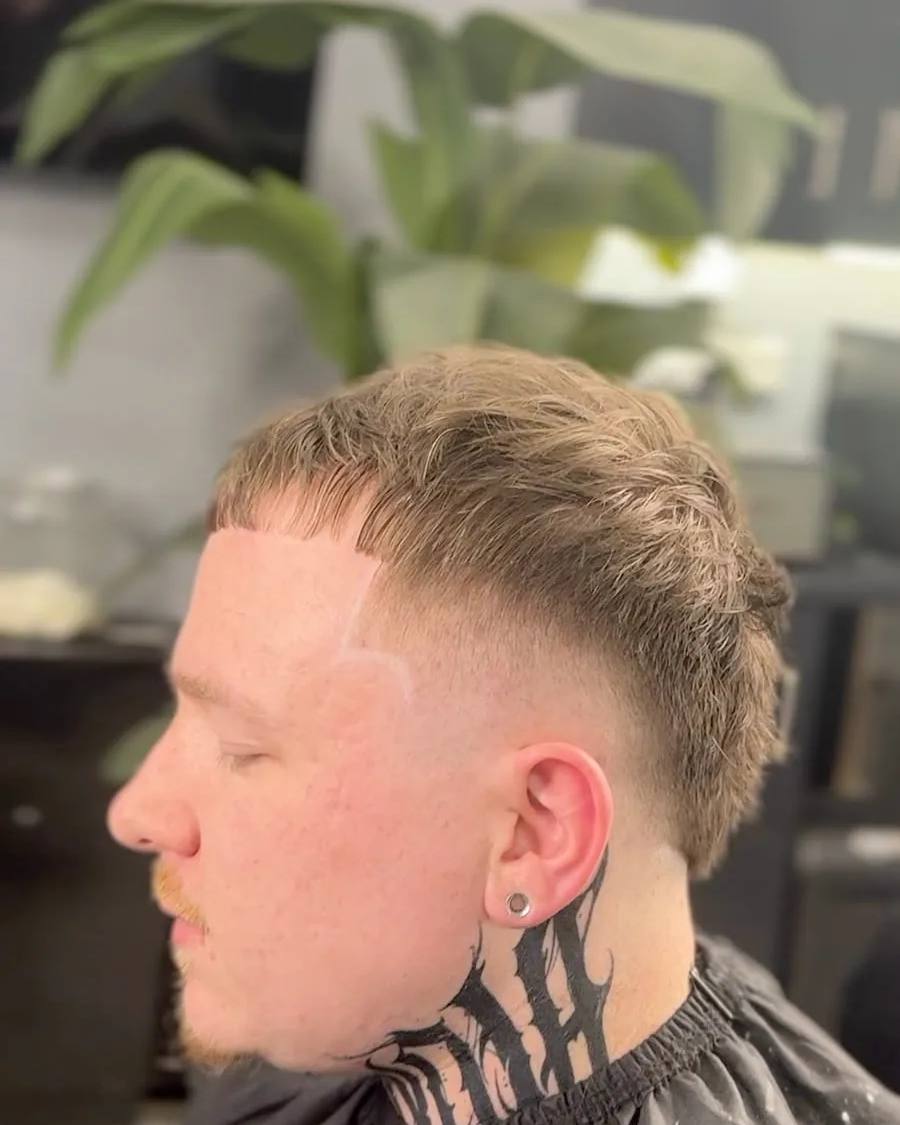 Burst fade with a neck tattoo at Chair and Blade