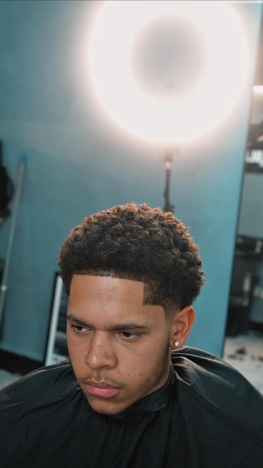 Afro with a sharp line-up, Chair and Blade Manchester