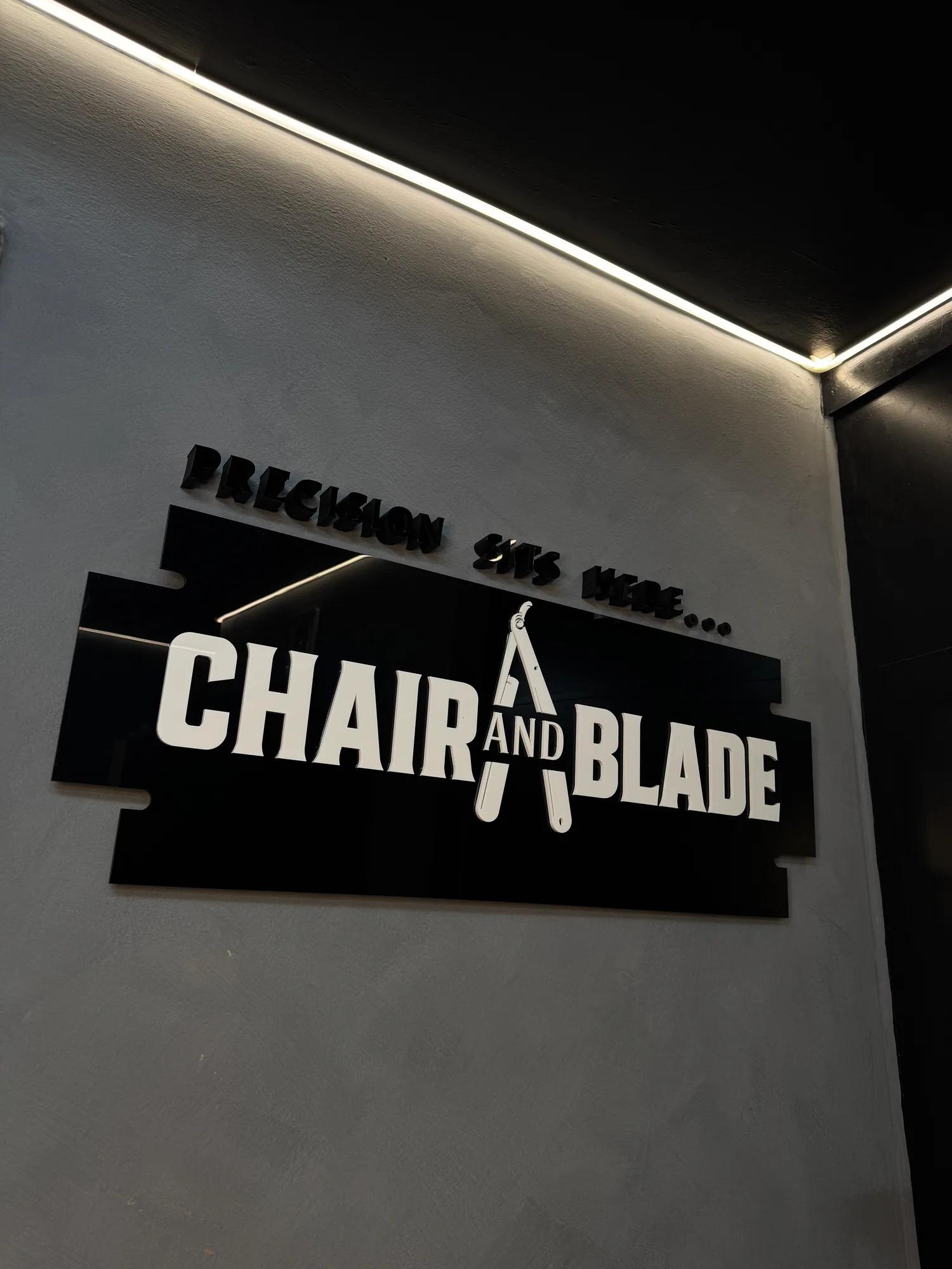 The Chair and Blade sign on the studio wall