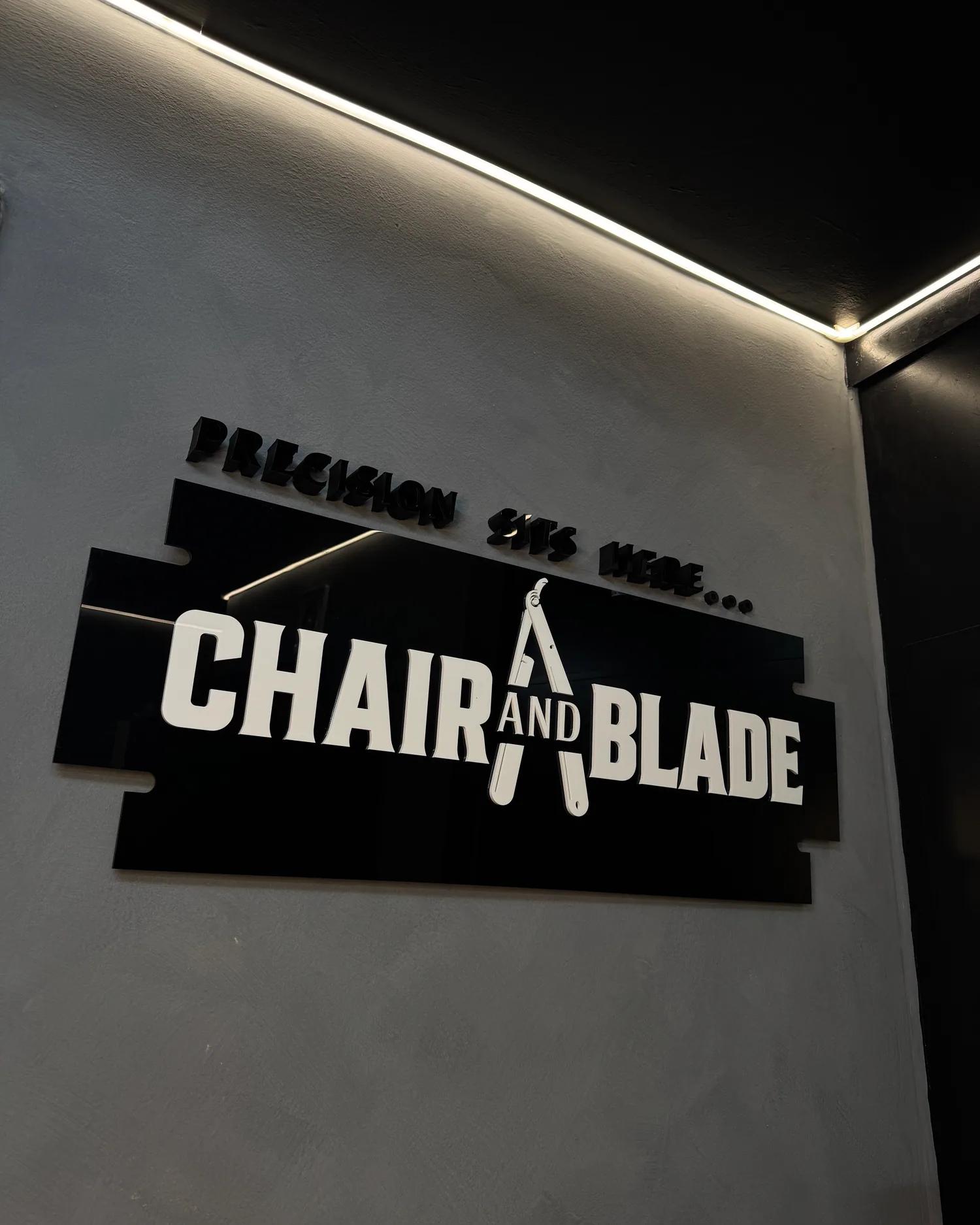 The Chair and Blade sign on the studio wall