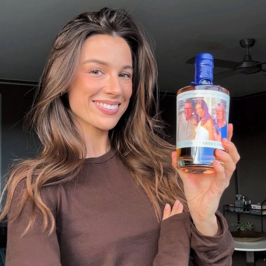 Happy customer holding personalised gin
