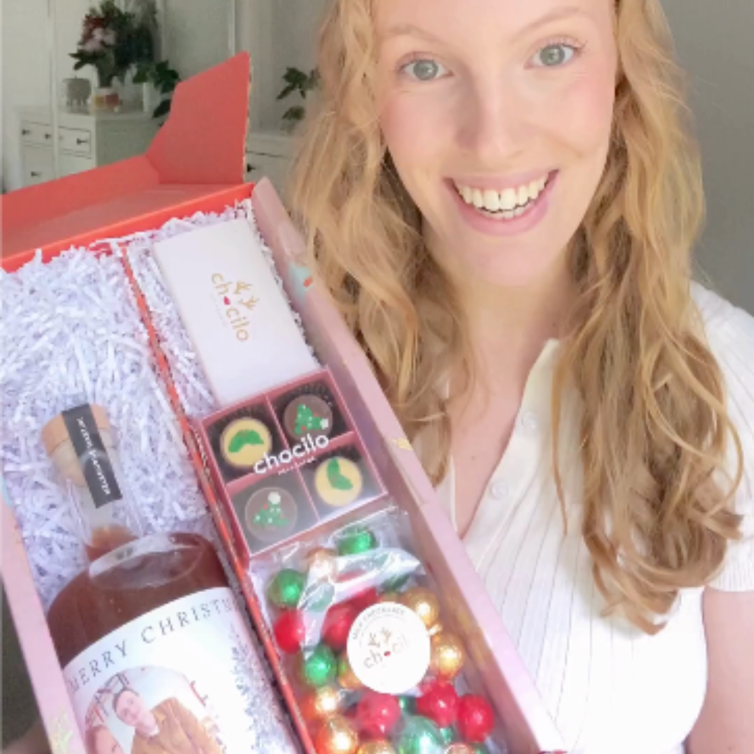 Couple toasting with personalised Christmas gifts