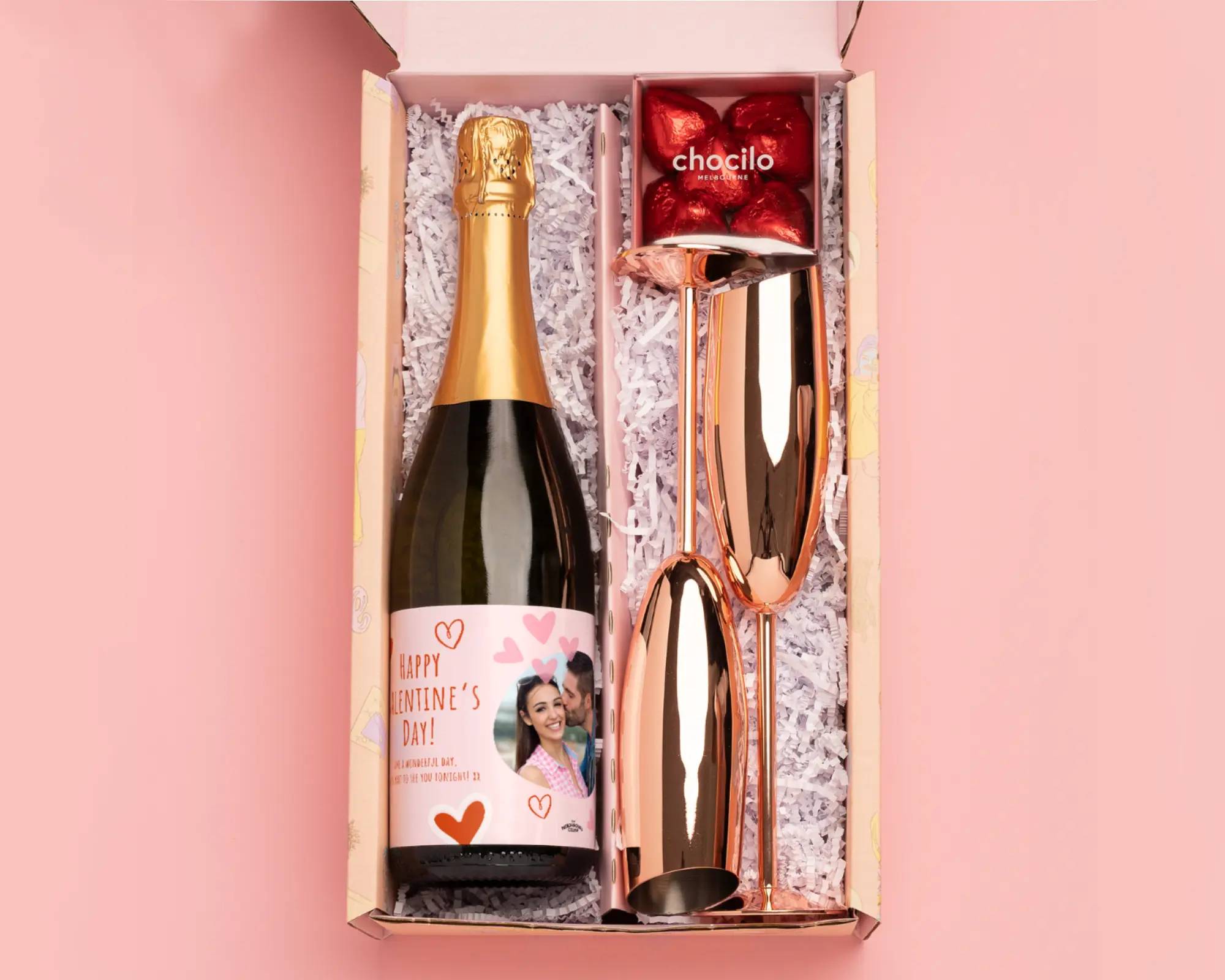 Stylish couple opening engagement gift box