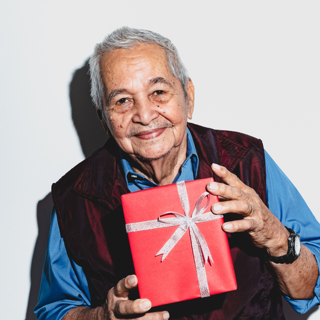 old man holding a gift