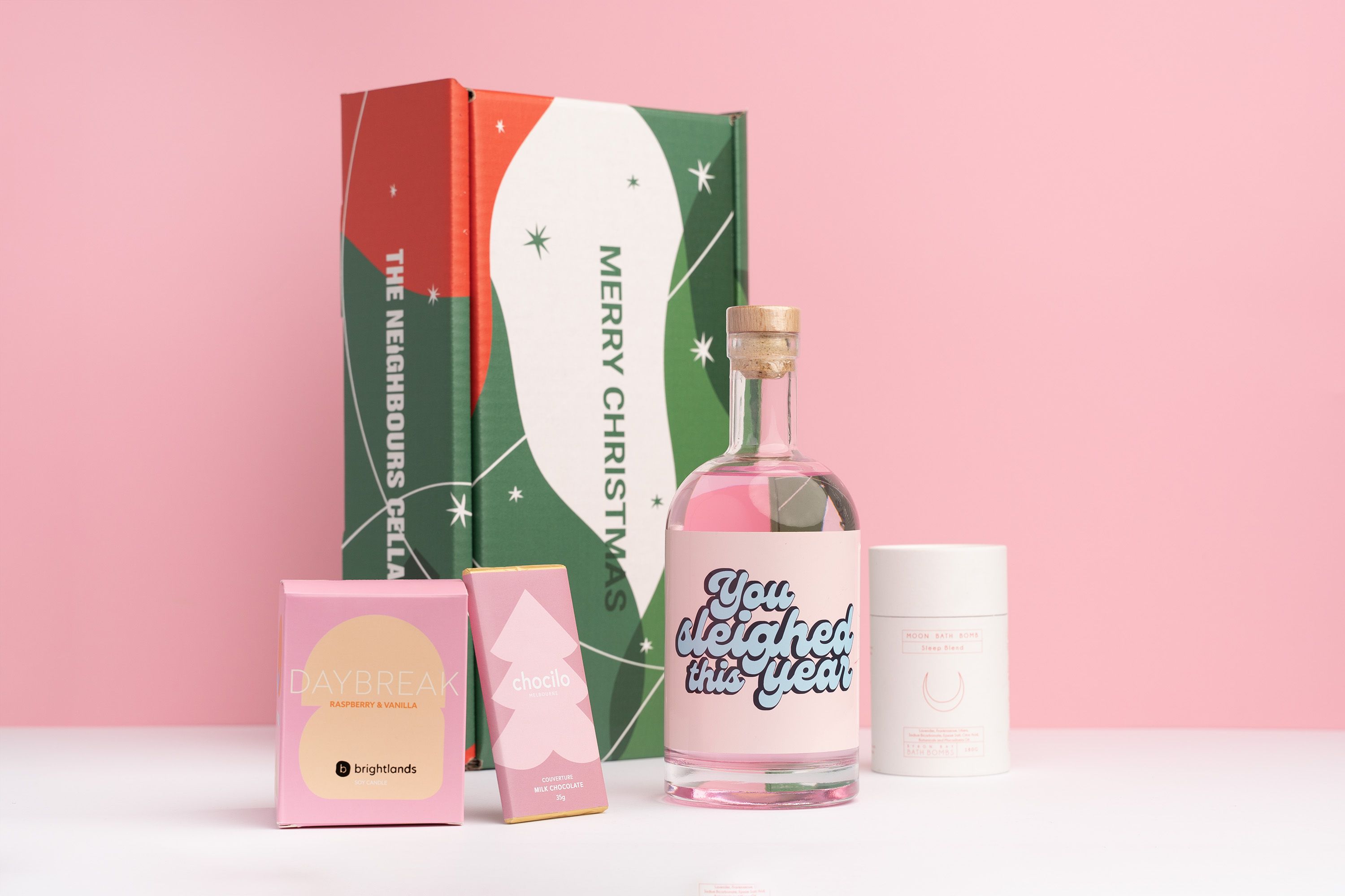 Personalised Gin Bottle in a Christmas gift box with a candle, chocolate bar and bath bomb