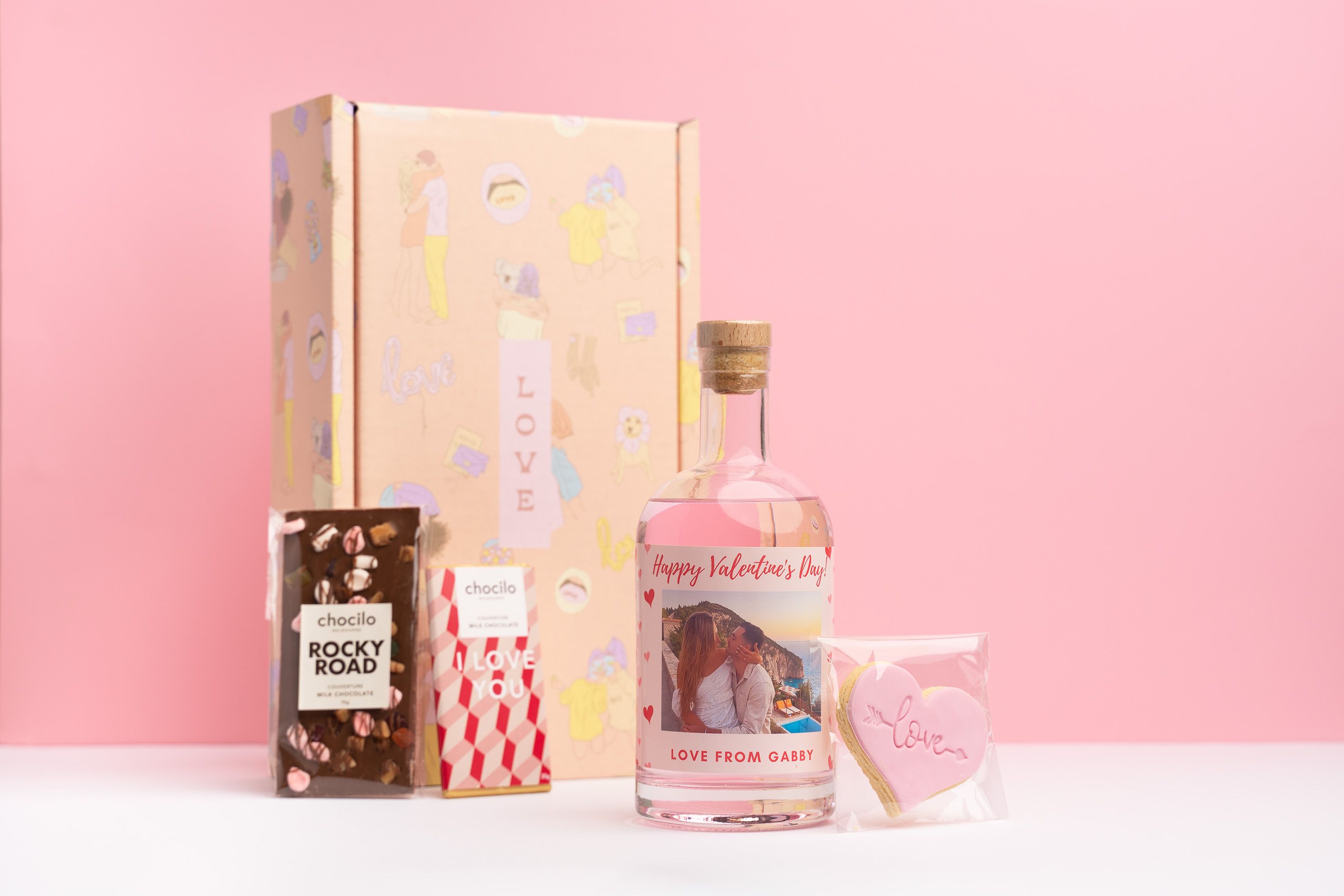 personalised pin gin bottle with a rocky road chocolate bar, I love you choc and love heart cookie in a love gift box