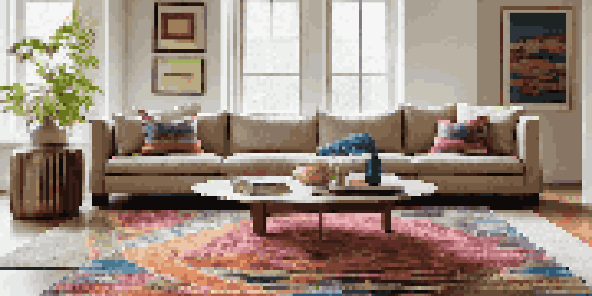 A colorful flatweave rug with geometric patterns on a modern living room floor, beneath a coffee table and surrounded by stylish furniture.