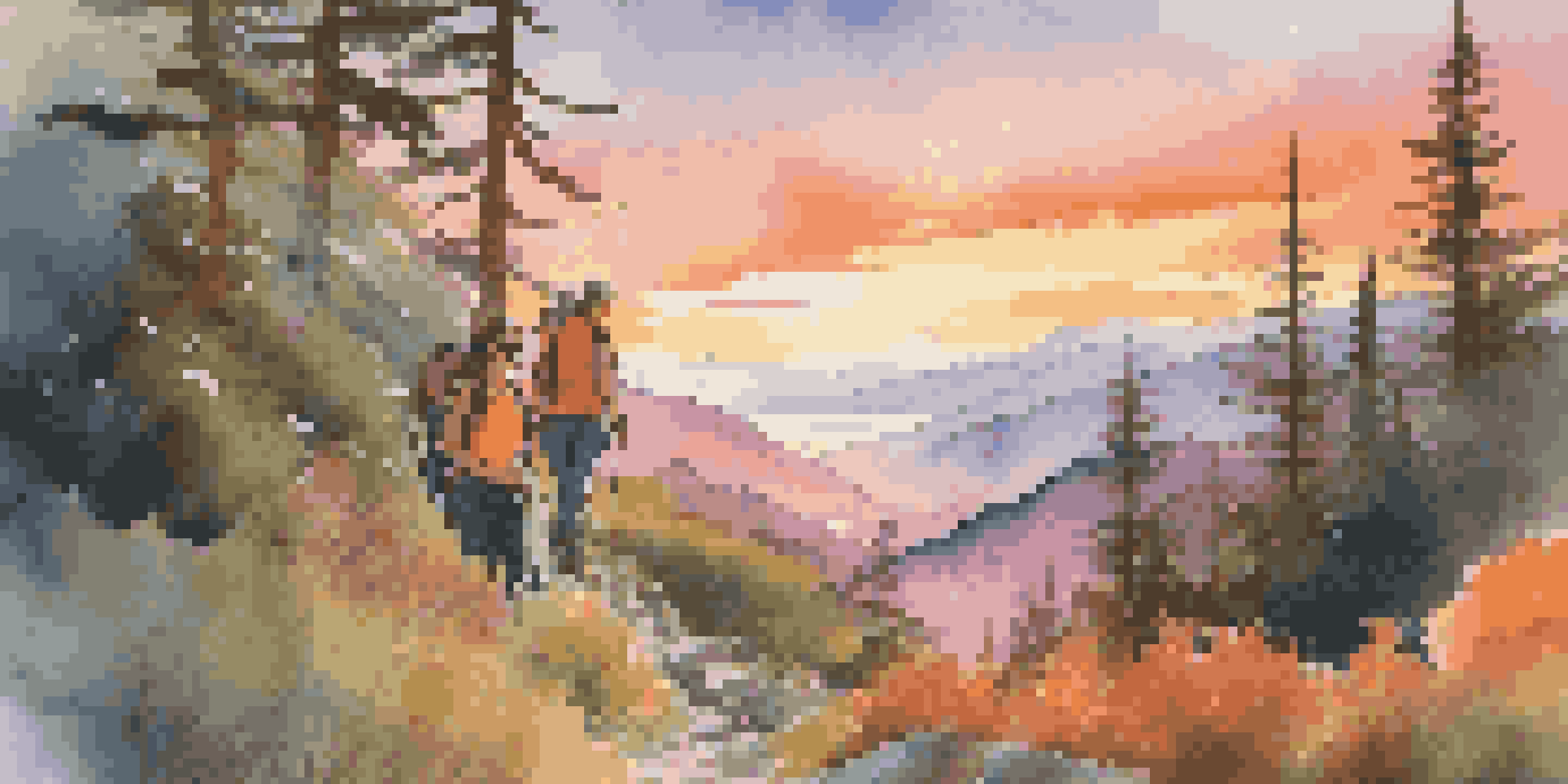 A couple smiling while hiking on a mountain trail at sunset, with colorful skies and greenery around them.