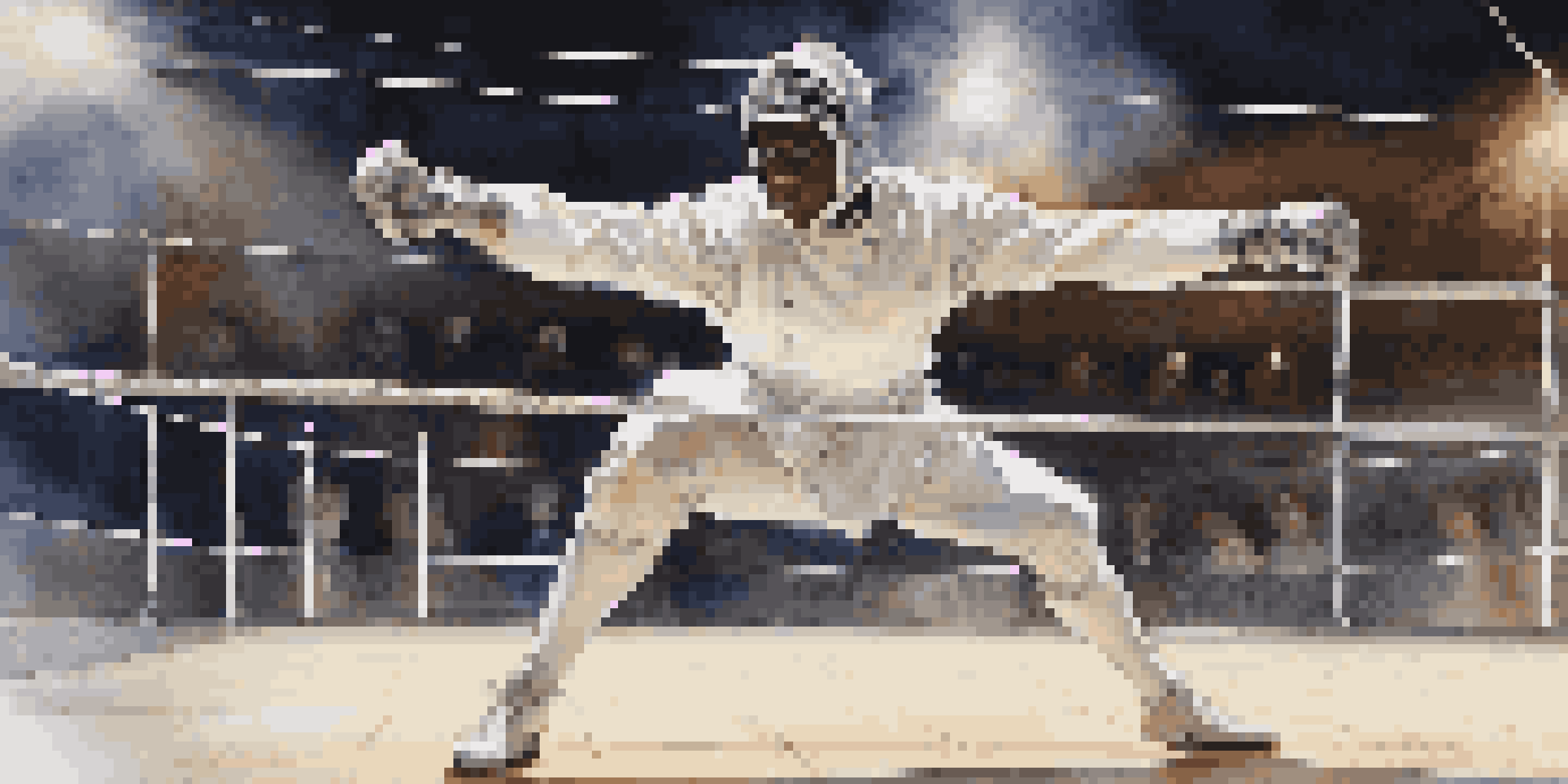 A fencer in a white uniform ready for action on a fencing strip, with a spotlight highlighting their focused expression and shiny blade.