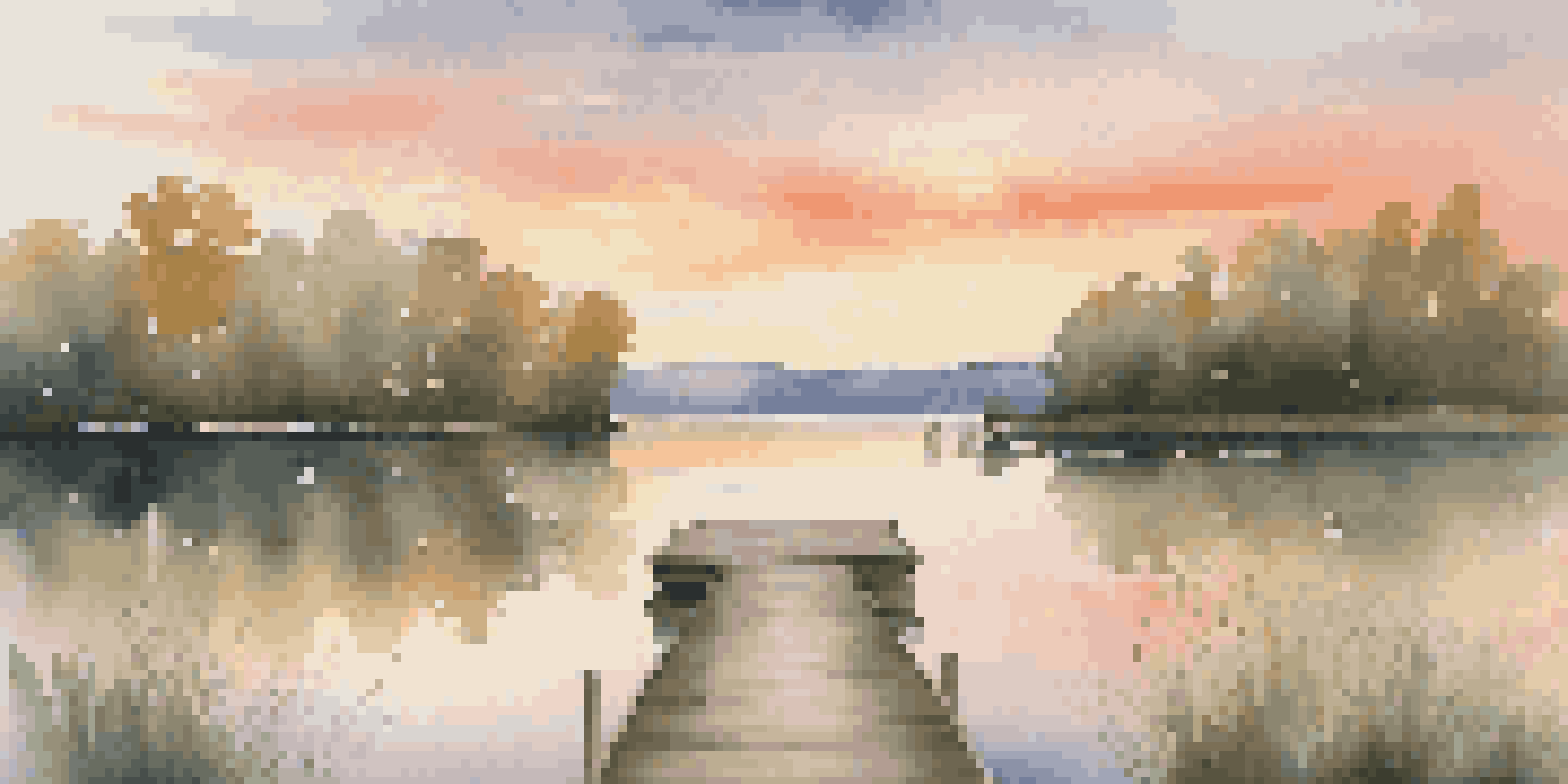 A tranquil lake at sunset, with warm colors in the sky and a wooden dock extending into the water, surrounded by greenery.