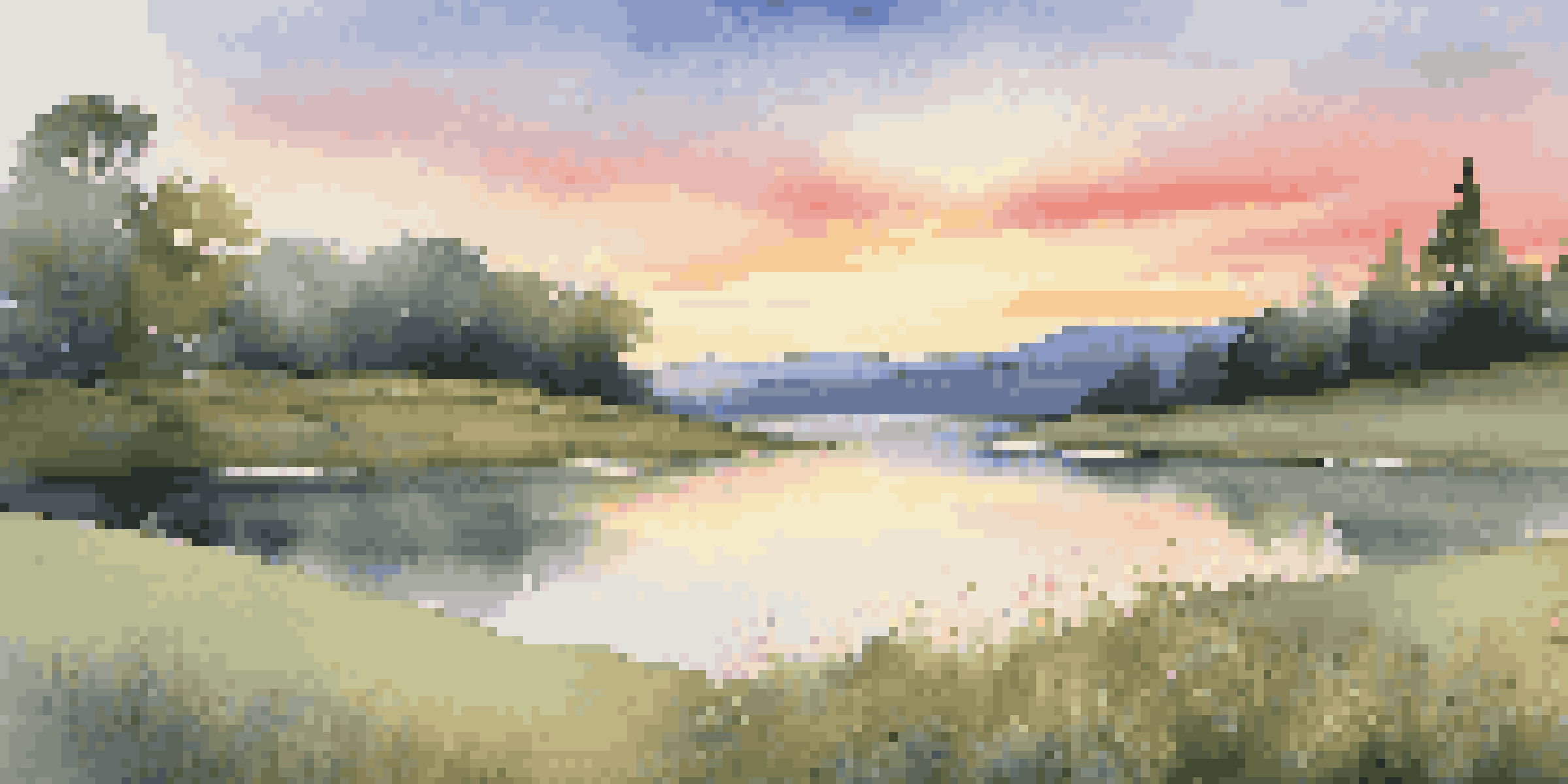 A peaceful sunrise landscape with a calm lake reflecting the colorful sky, surrounded by green grass and wildflowers.