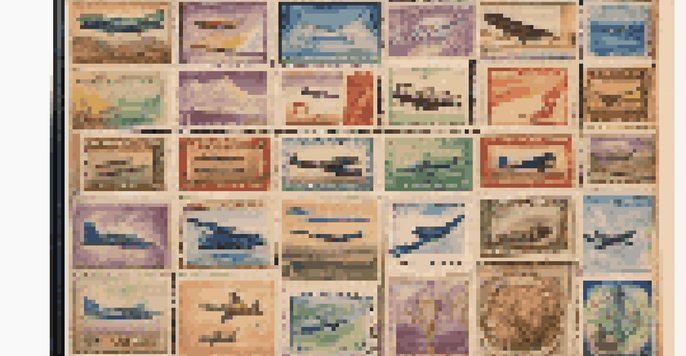 A close-up of a vintage air mail stamp collection in a wooden album, featuring colorful and intricately designed stamps.