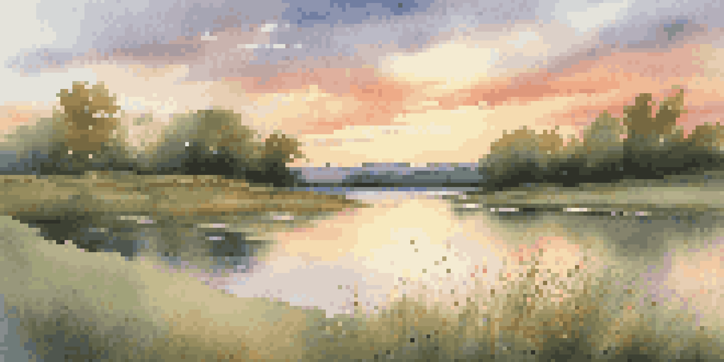 A tranquil lake at sunset with warm colors reflecting on the water and wildflowers in the foreground.