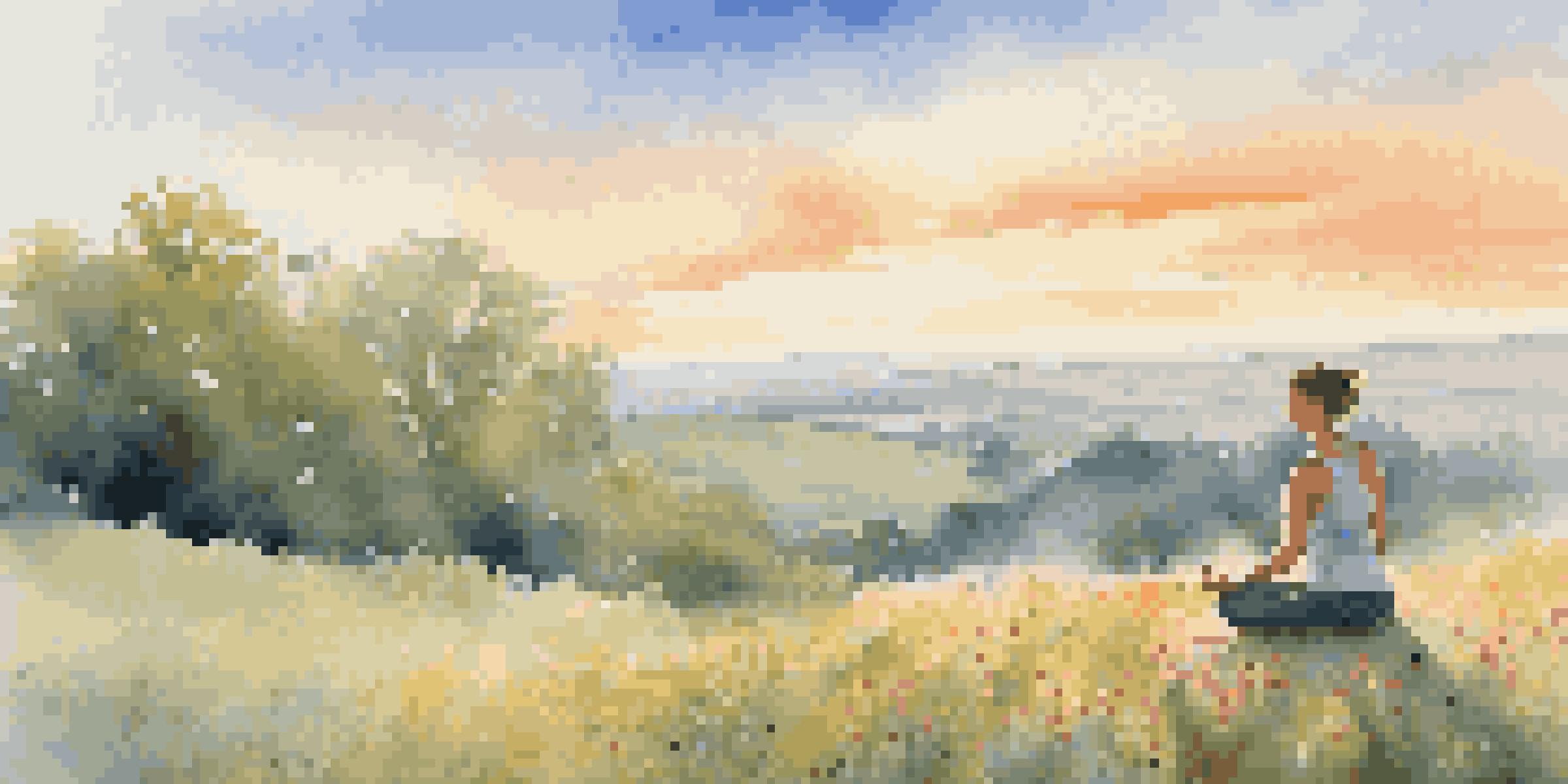 A person doing yoga on a grassy hill at sunrise, surrounded by colorful wildflowers.
