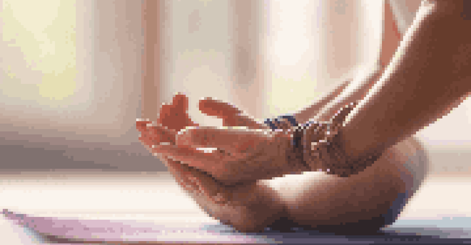 Close-up of a person's hands in a prayer position during yoga, with a softly lit background of yoga mats and decor.