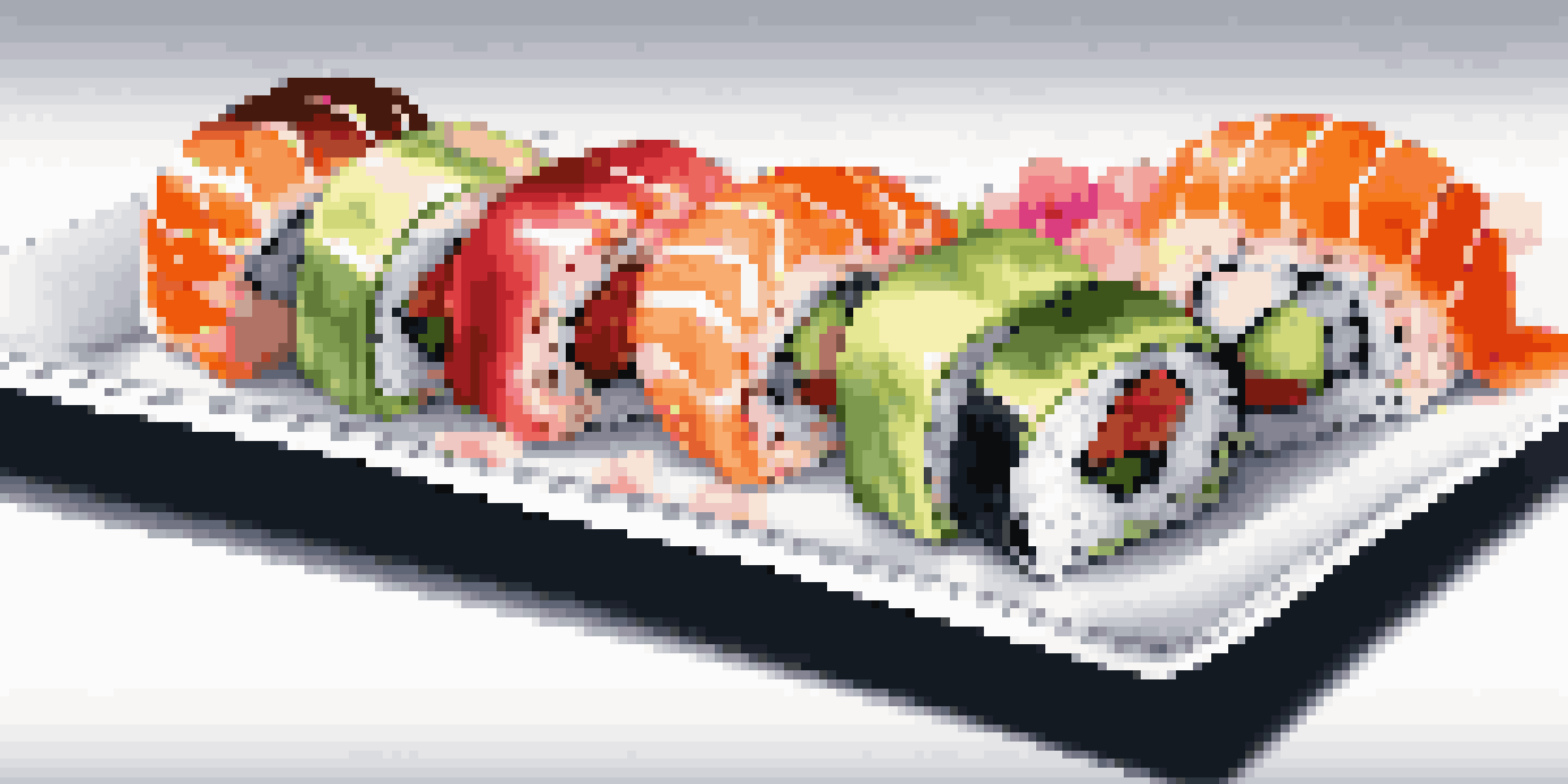 A platter of colorful gourmet sushi rolls arranged on a white plate, garnished with pickled ginger and wasabi, with a softly blurred background.