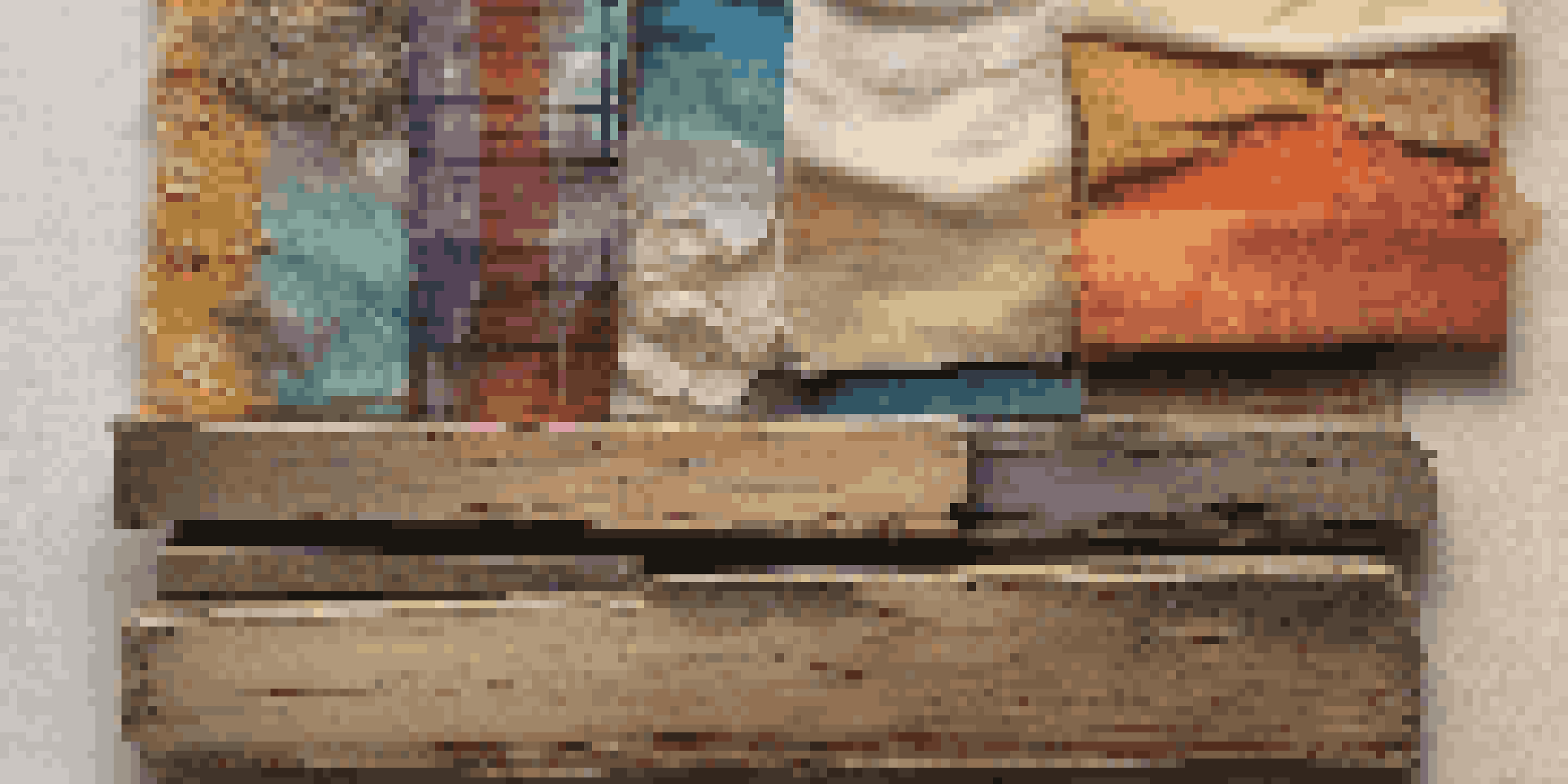 A colorful mixed media artwork showcasing a combination of wood, fabric, and a vintage photo, illuminated by soft light.