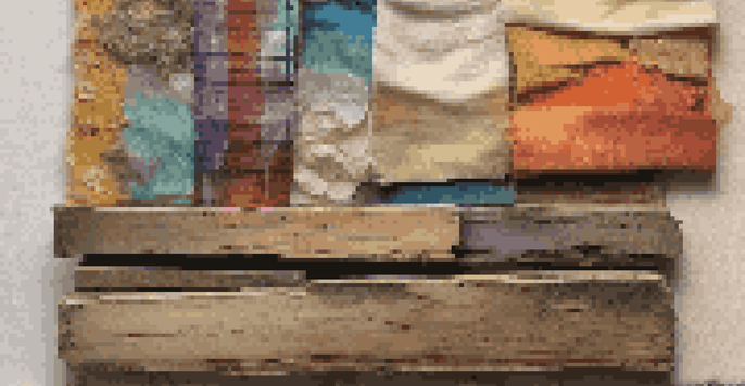 A colorful mixed media artwork showcasing a combination of wood, fabric, and a vintage photo, illuminated by soft light.