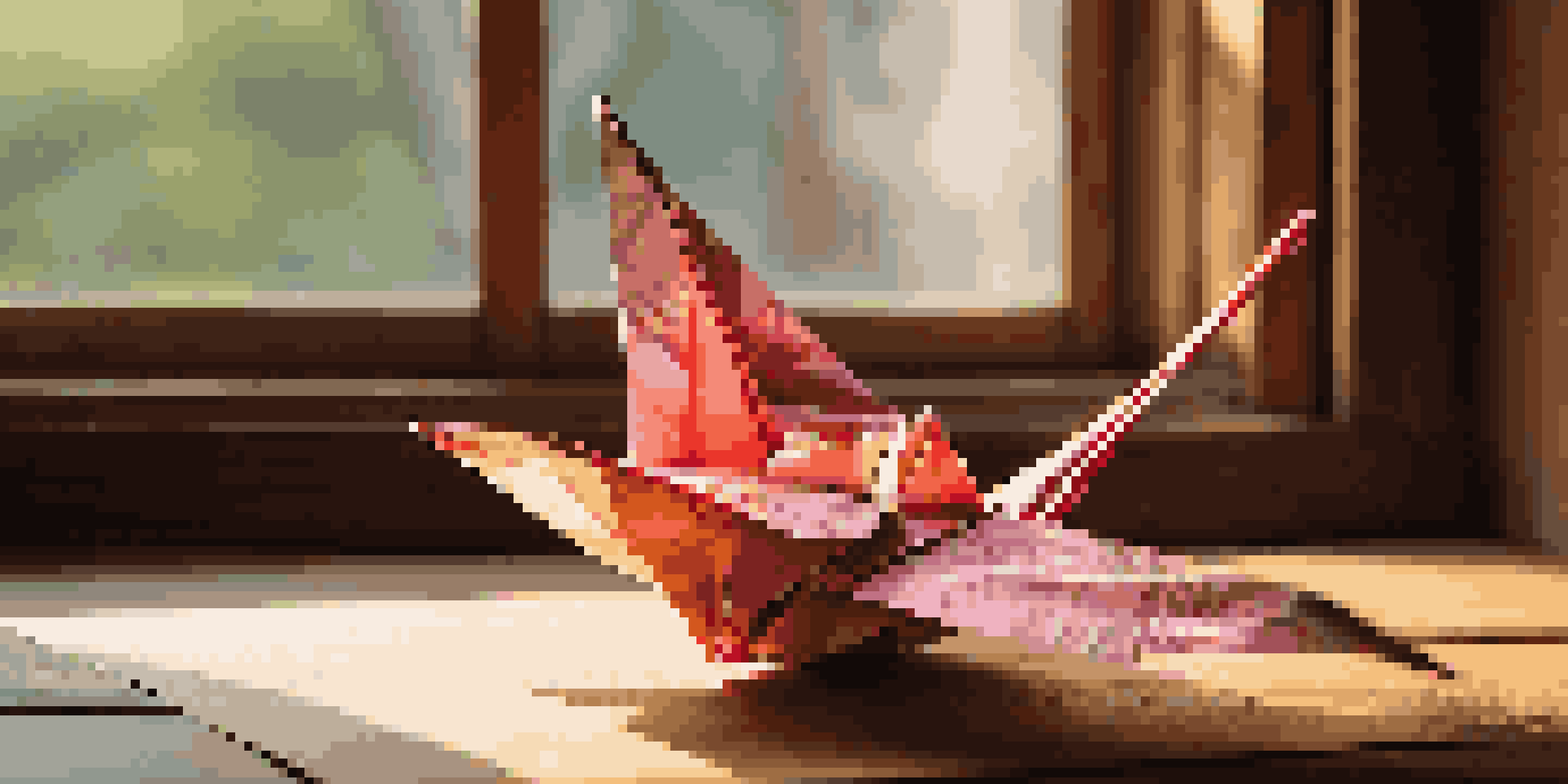 A detailed close-up of a colorful origami crane on a wooden table, with soft natural light enhancing its textures and folds.