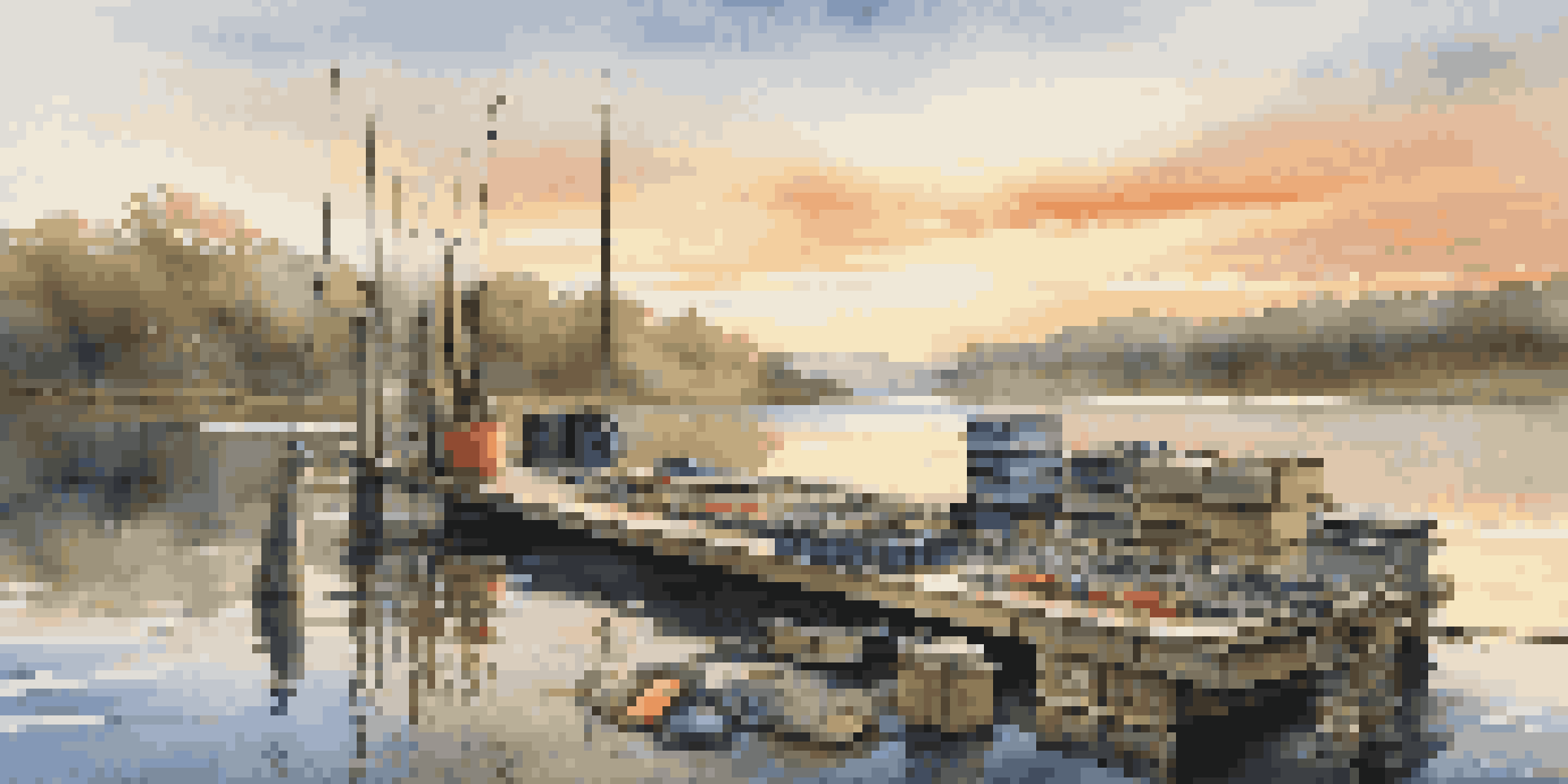 A peaceful morning scene of an organized fishing gear setup on a dock, showcasing tackle boxes and fishing rods in warm light.