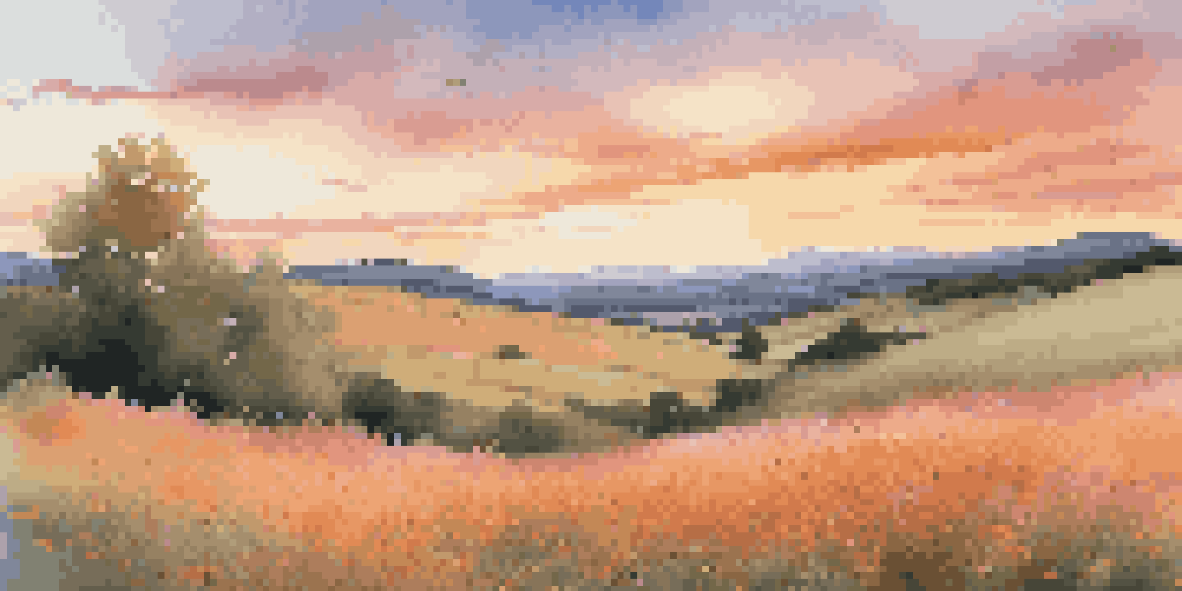 A serene landscape at sunset with rolling hills, warm light, and a field of colorful wildflowers.