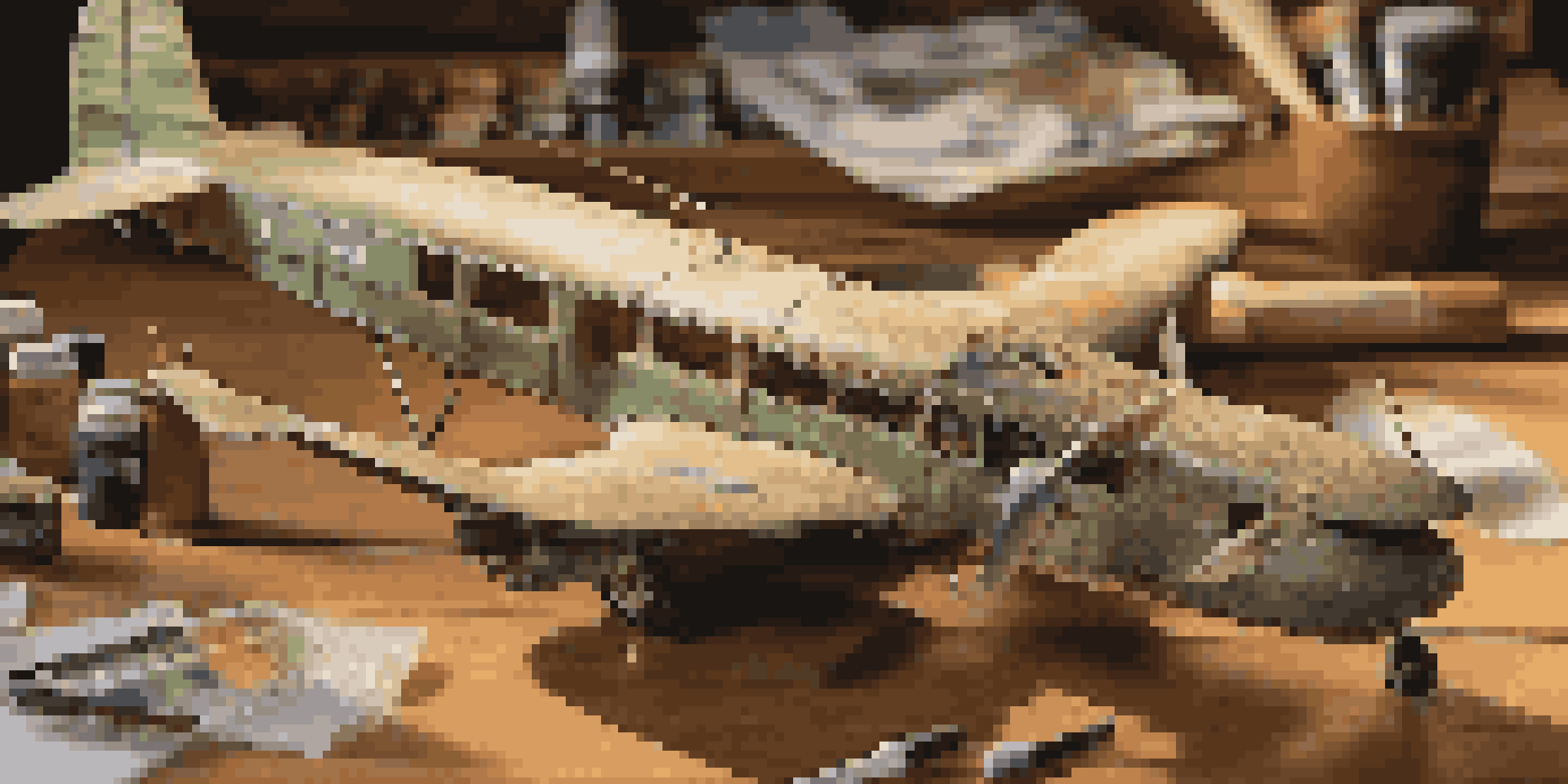 A detailed scale model aircraft on a workbench with tools and paints around it, illuminated by warm lighting.