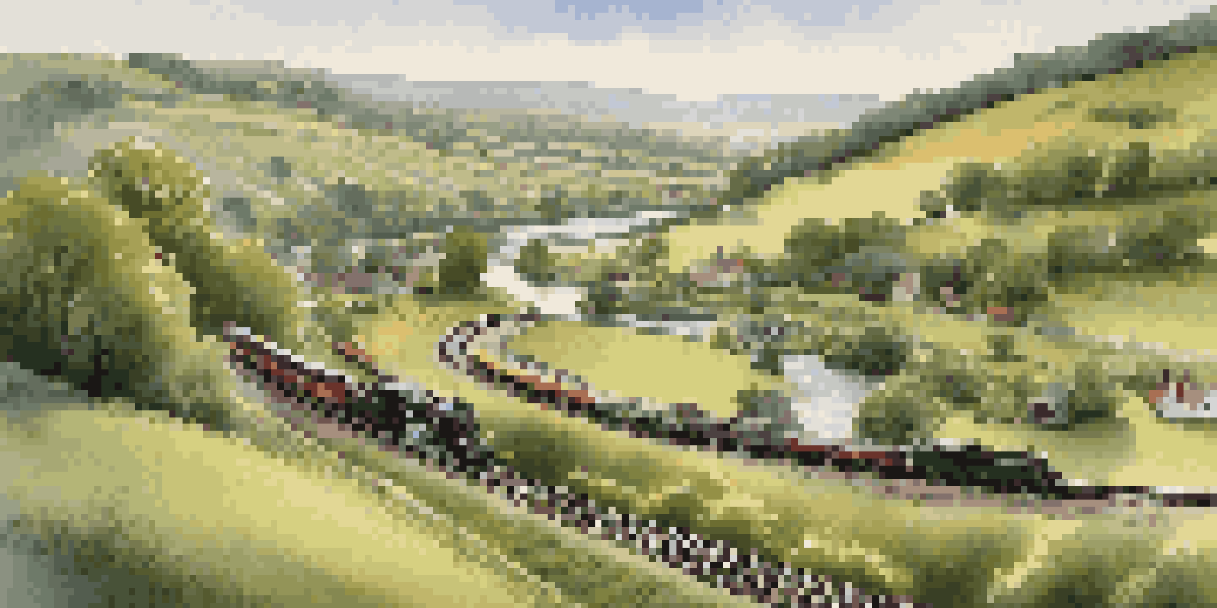 A model railroad scene showcasing a calm countryside with hills, a river, and a village under warm sunlight.
