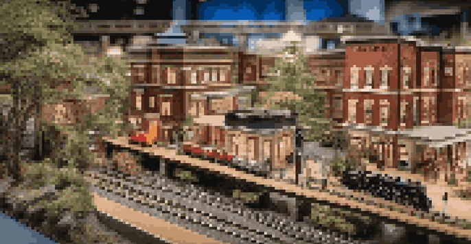 A detailed model railroad layout with tracks, buildings, and scenery illuminated by soft LED lights.