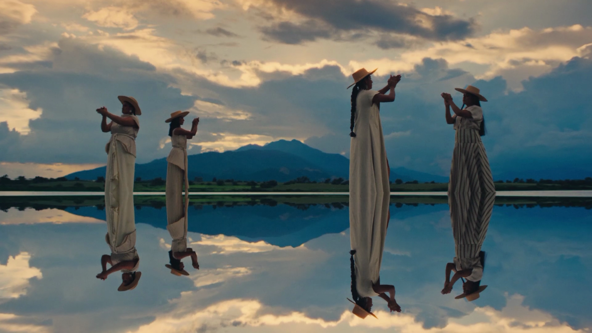 Women clapping and standing on water