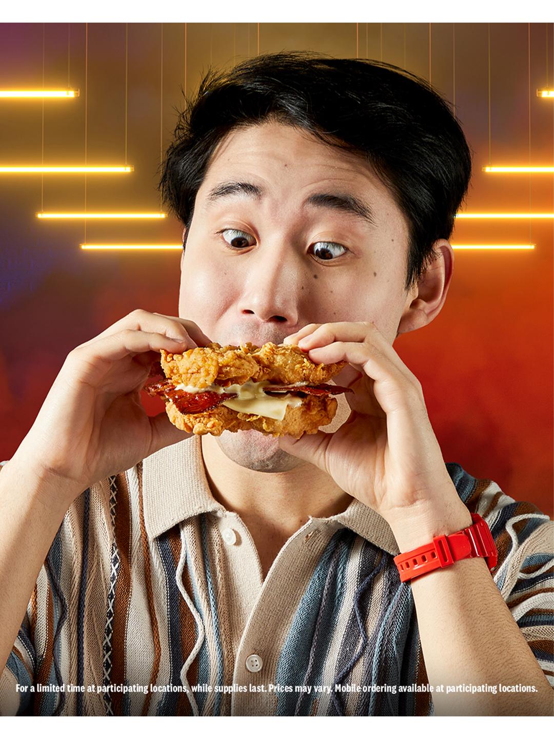guy biting into double down sandwich