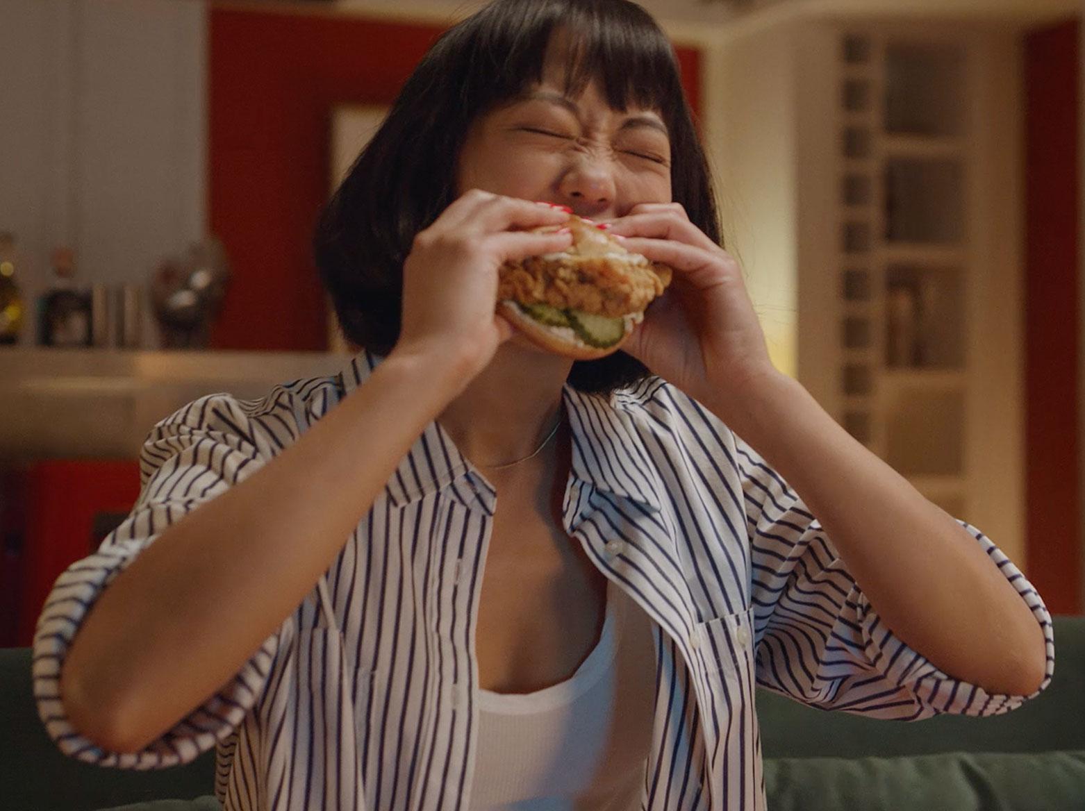 man eating a chicken sandwich