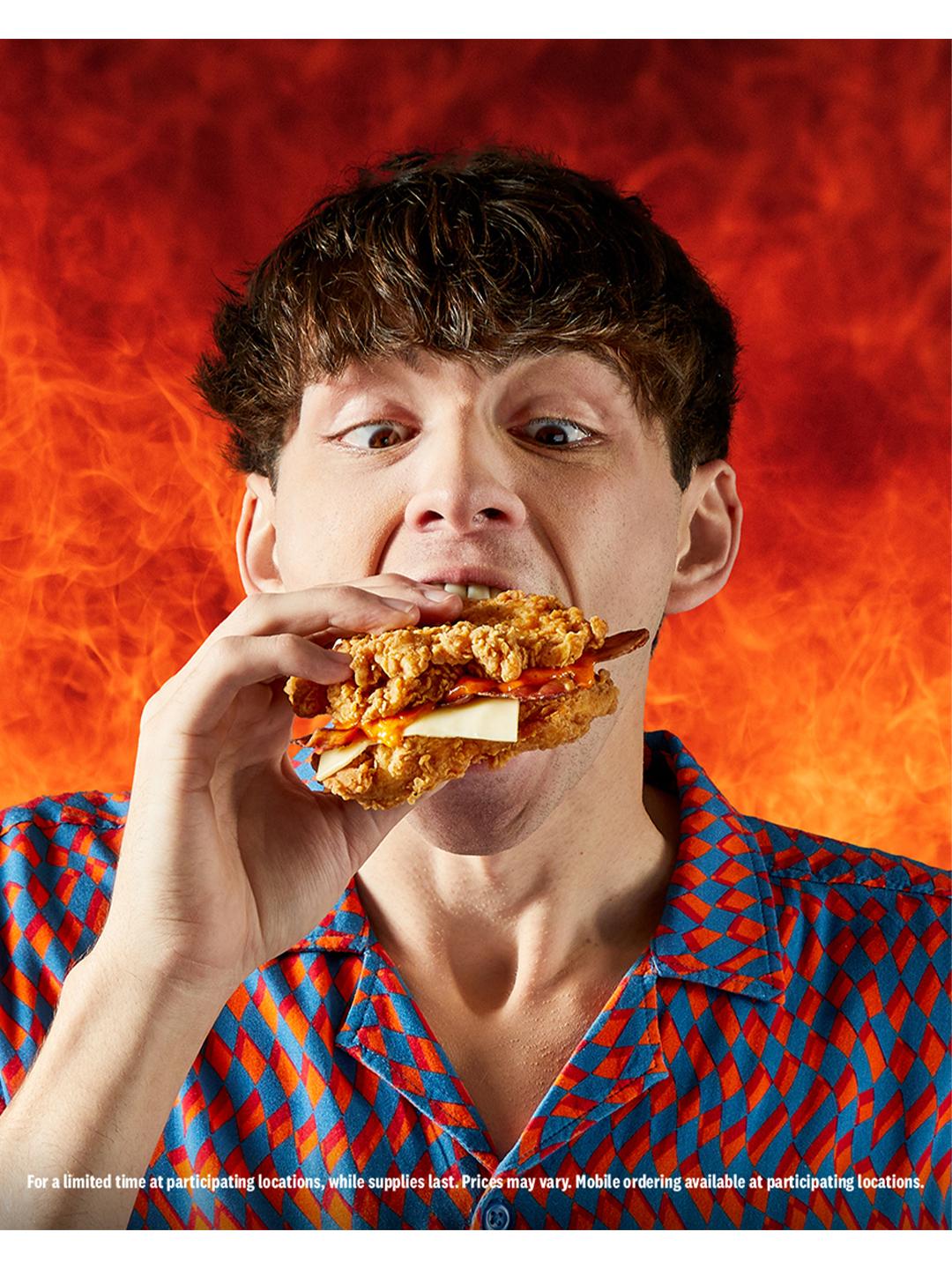 guy biting into double down sandwich