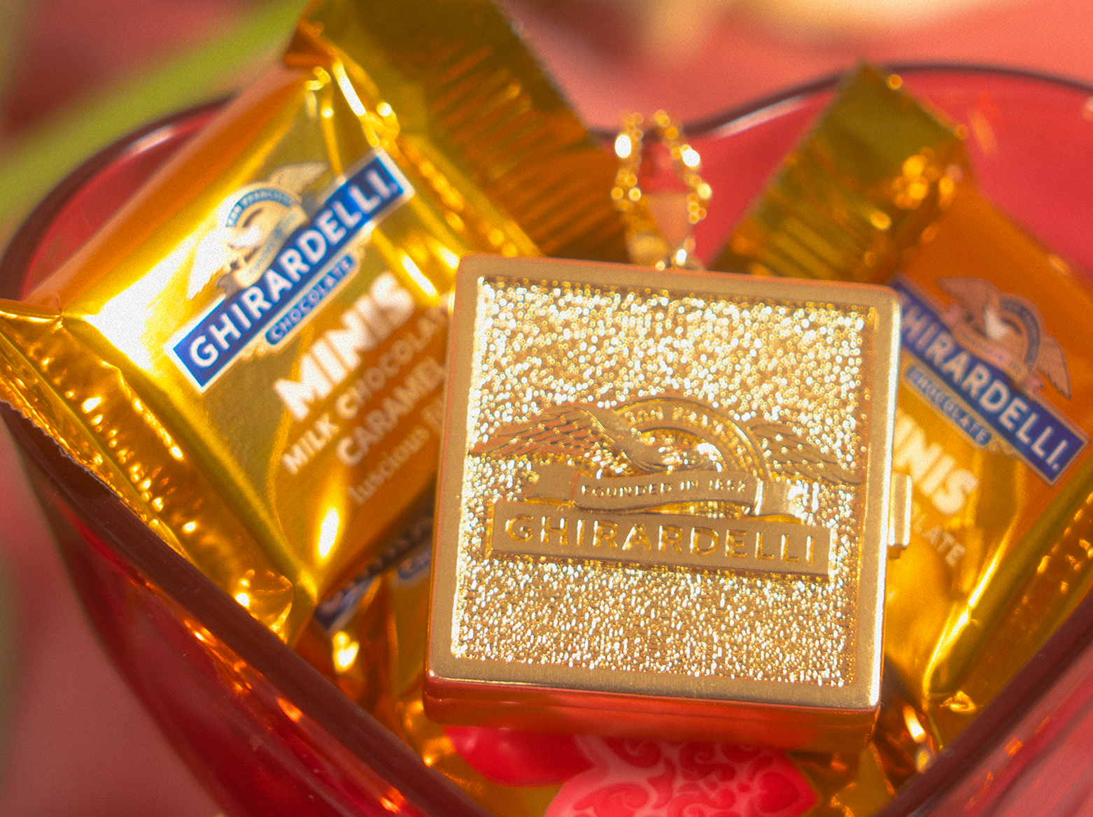 Ghirardelli 'Chocolocket' necklace hanging with locket open revealing square of chocolate