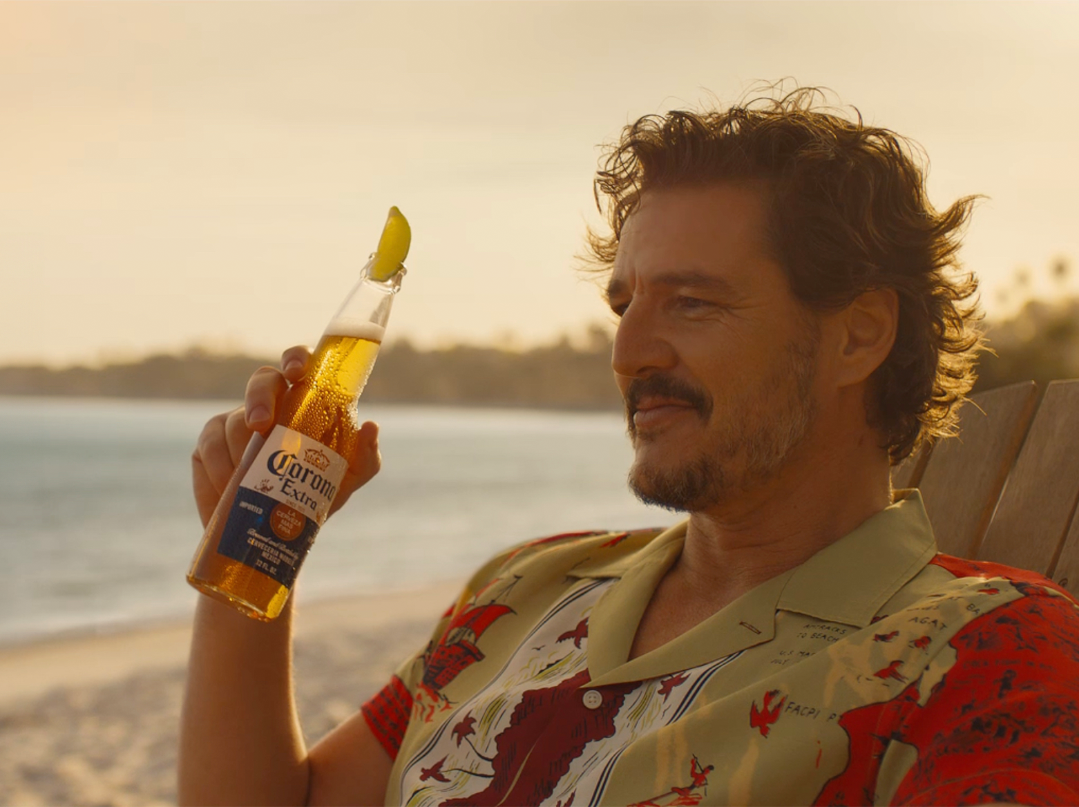 Pedro Pascal on the beach with a Corona