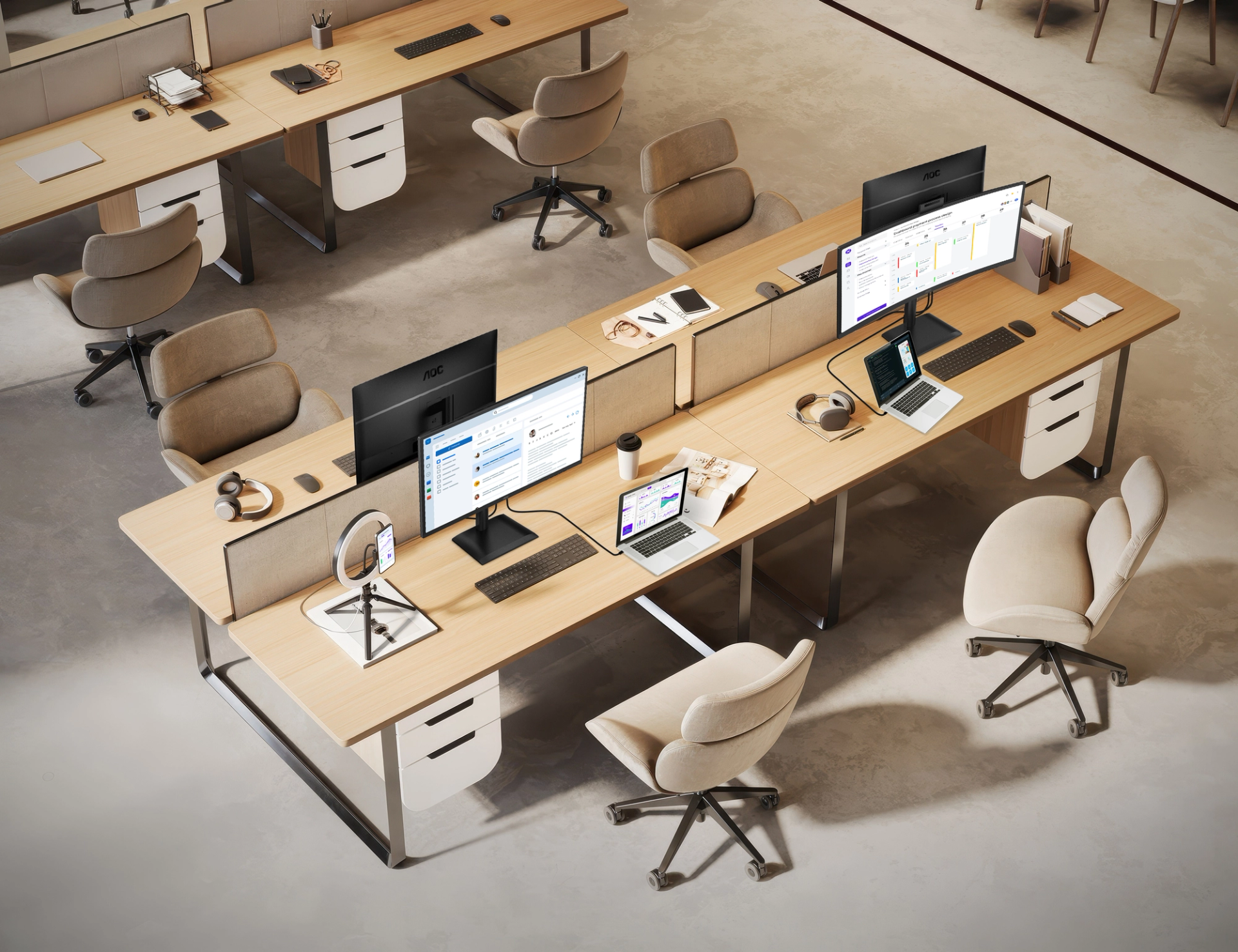 Modern SMB office workspace featuring AOC monitors, shared wooden desks, ergonomic chairs, laptops, and collaborative workstations in an open-plan business environment.