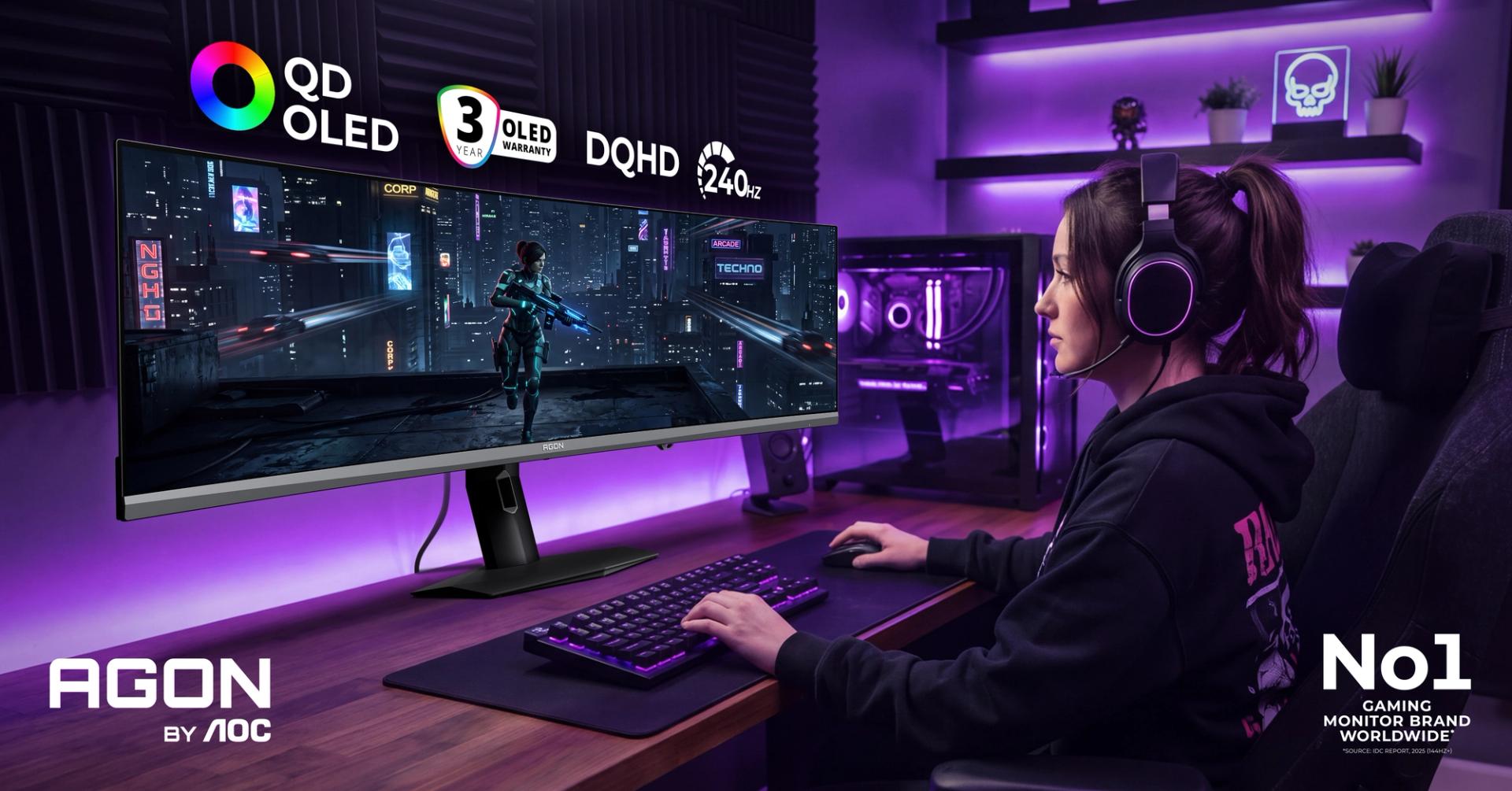 Gamer using an AGON by AOC QD-OLED ultrawide gaming monitor in a purple-lit gaming setup.