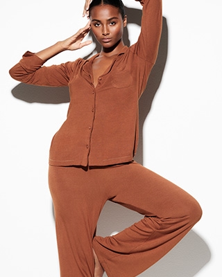 A MODEL POSES WEARING SKIMS SLEEP