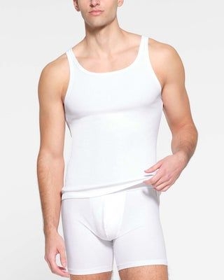 A model poses wearing SKIMS COTTON